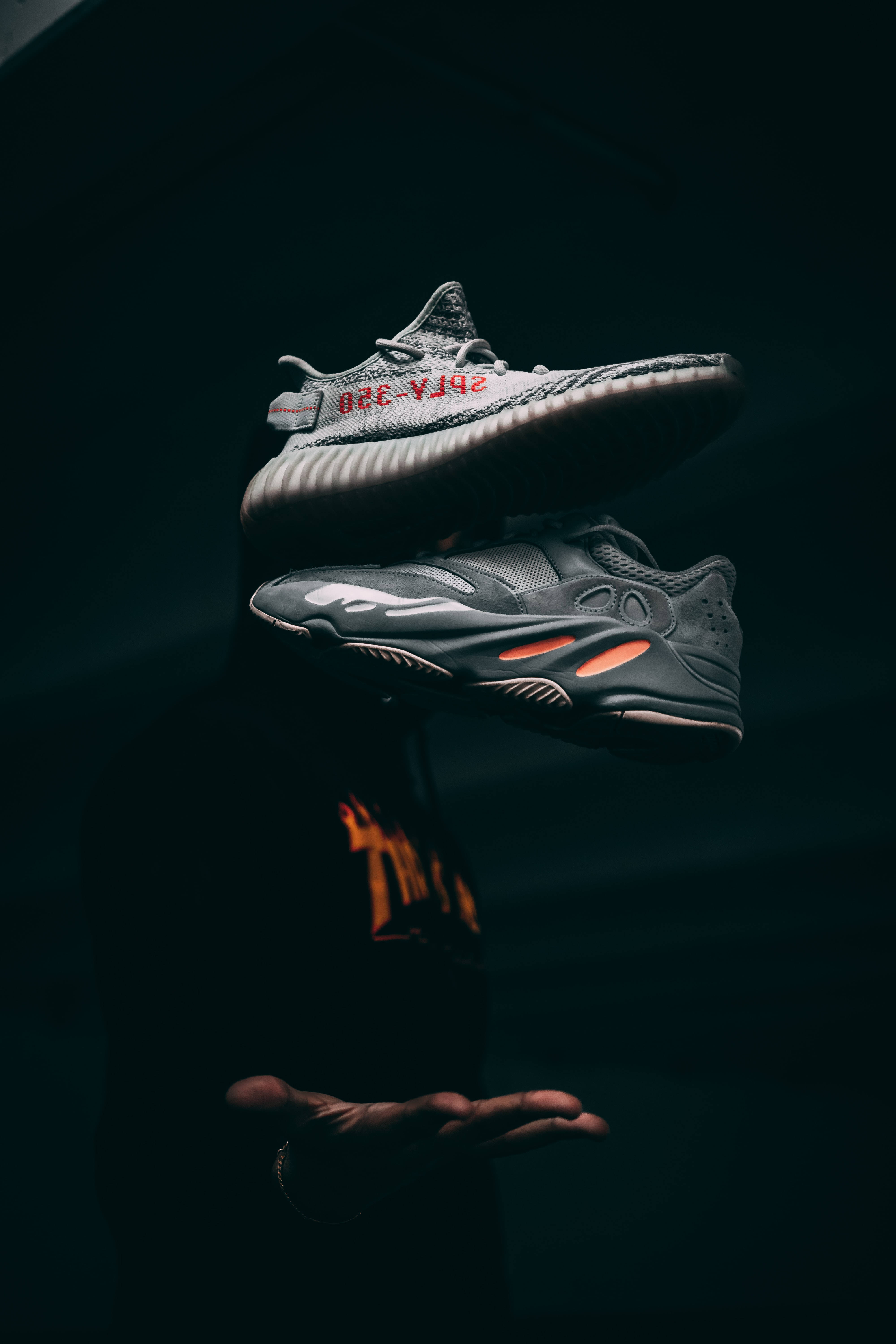 floating sneakers, outstretched hand, dark studio, 5K Phone Wallpaper