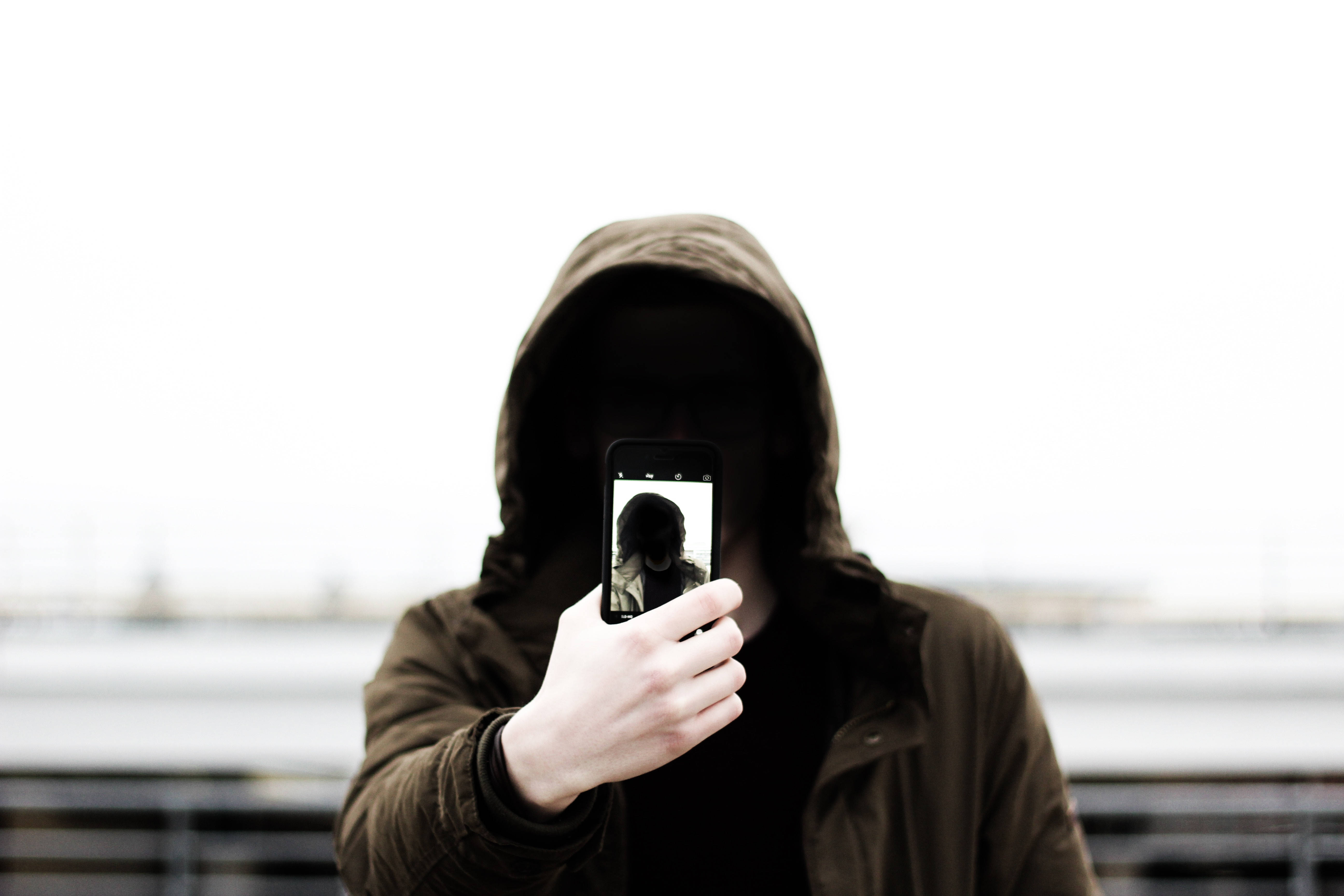 smartphone, hooded person, phone displaying their own face, 5K Desktop Wallpaper