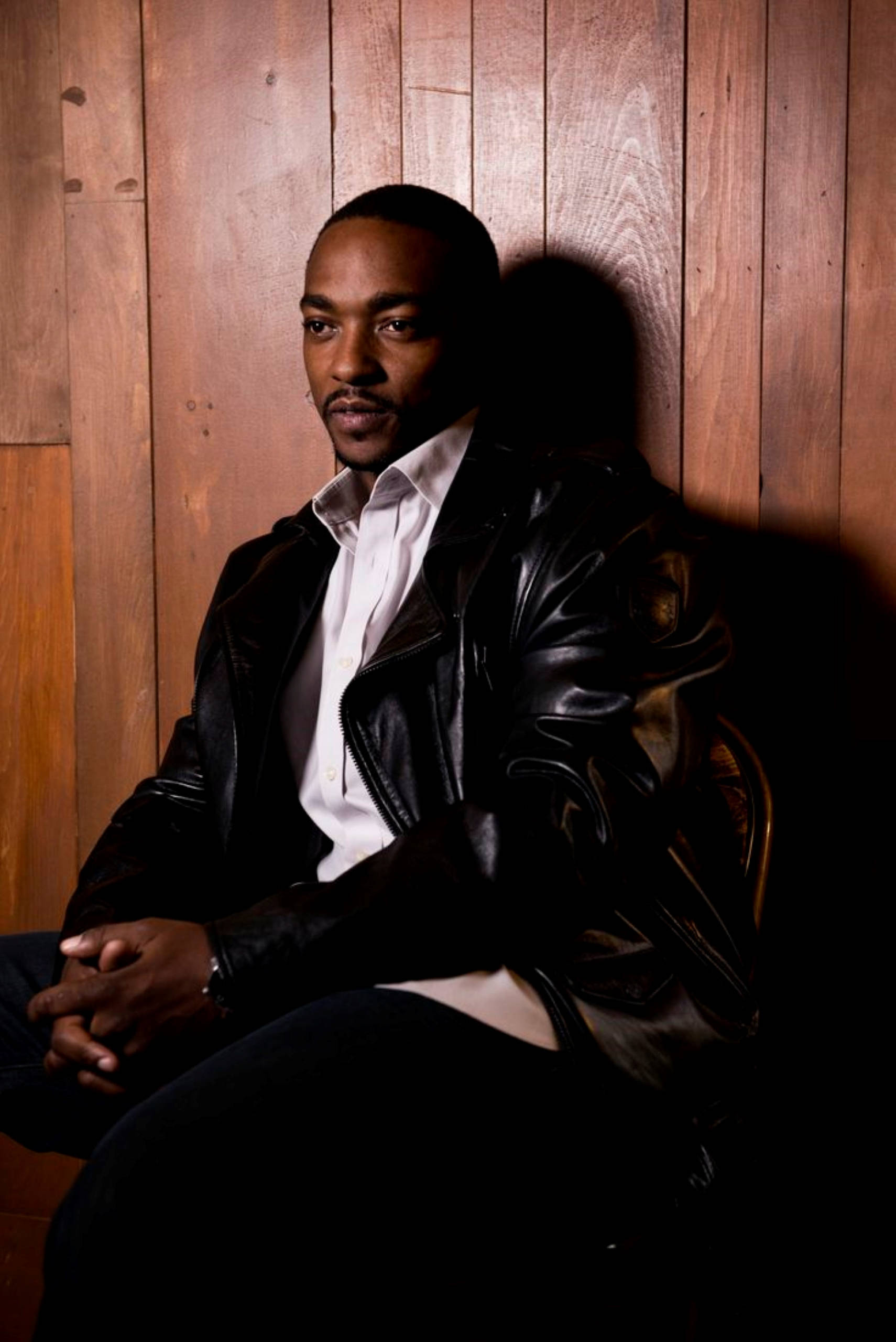 Anthony Mackie, black leather jacket, warm wooden wall, 2K Phone Wallpaper