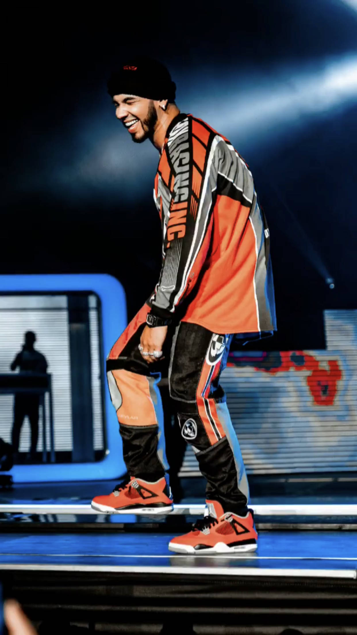 Anuel AA, orange gray and black racing gear, lit stage, Full HD Phone Wallpaper