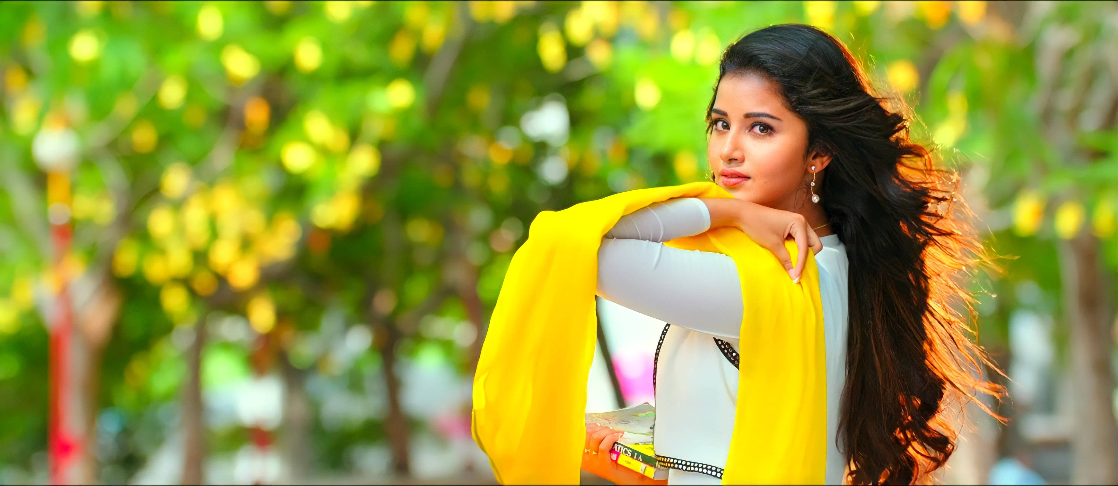 Anupama Parameswaran, yellow scarf, sunlit green foliage backdrop, 4K Desktop Wallpaper