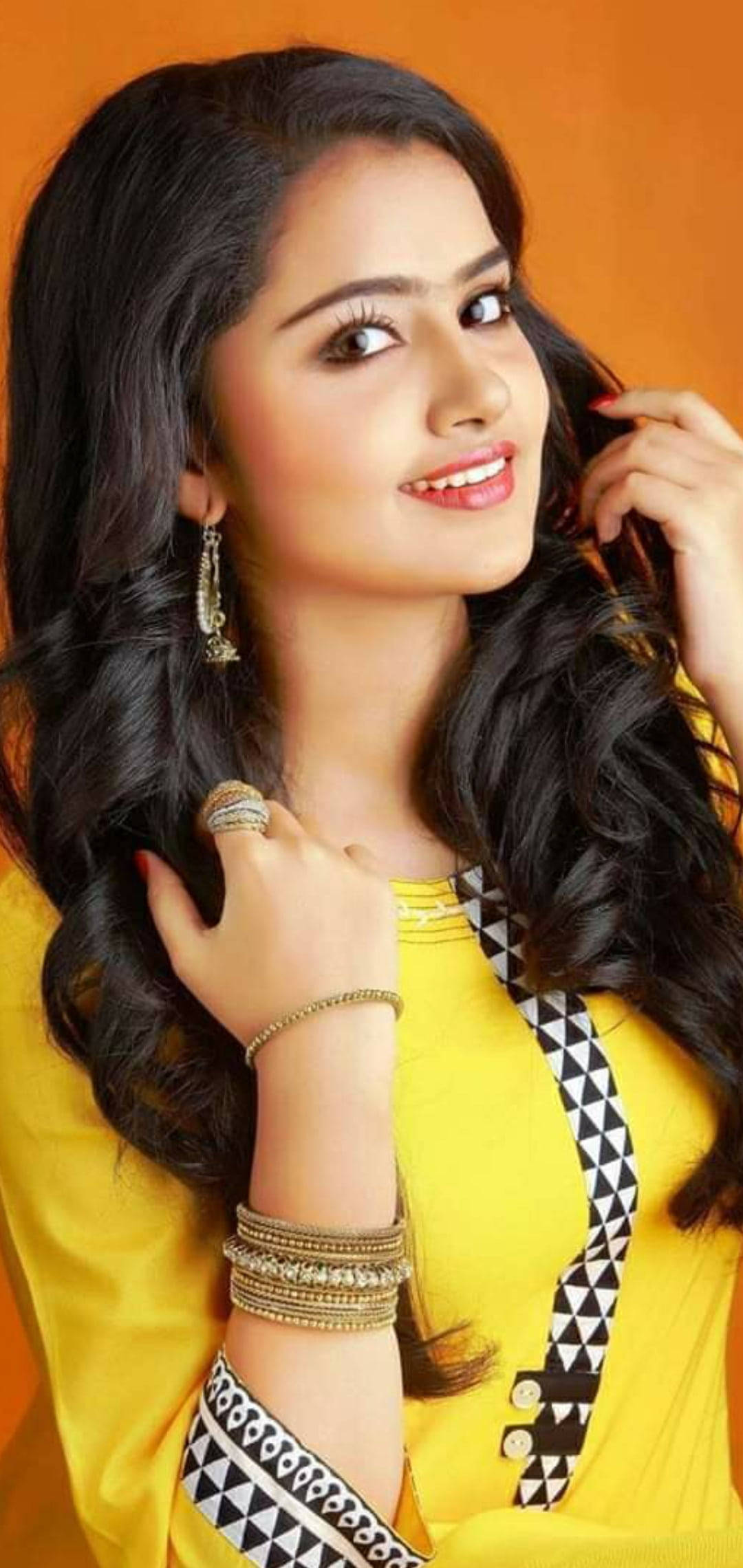 Anupama Parameswaran, long dark hair, warm orange background, Full HD Phone Wallpaper