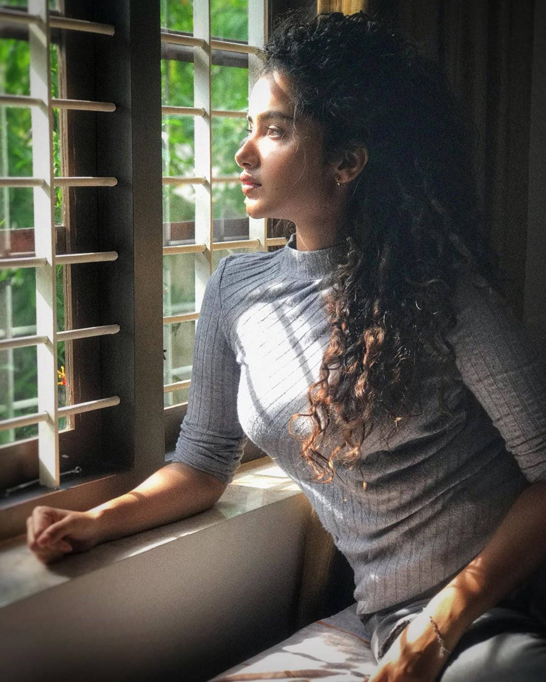 Anupama Parameswaran, sunlit window, curly hair, HD Phone Wallpaper