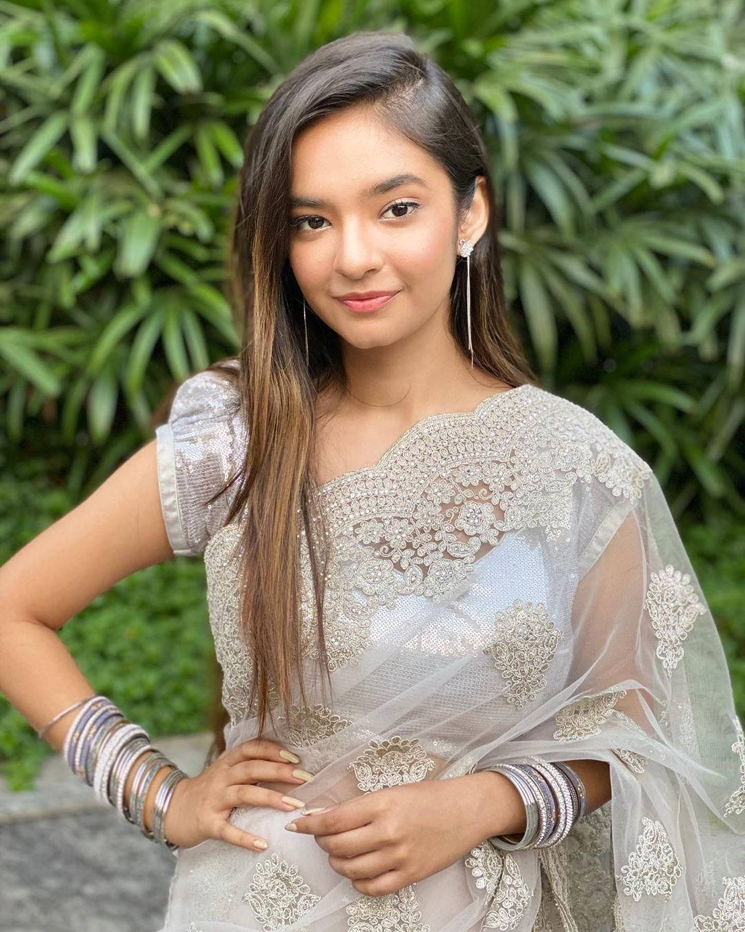 Anushka Sen, silver embroidered sari, lush green foliage backdrop, HD Phone Wallpaper