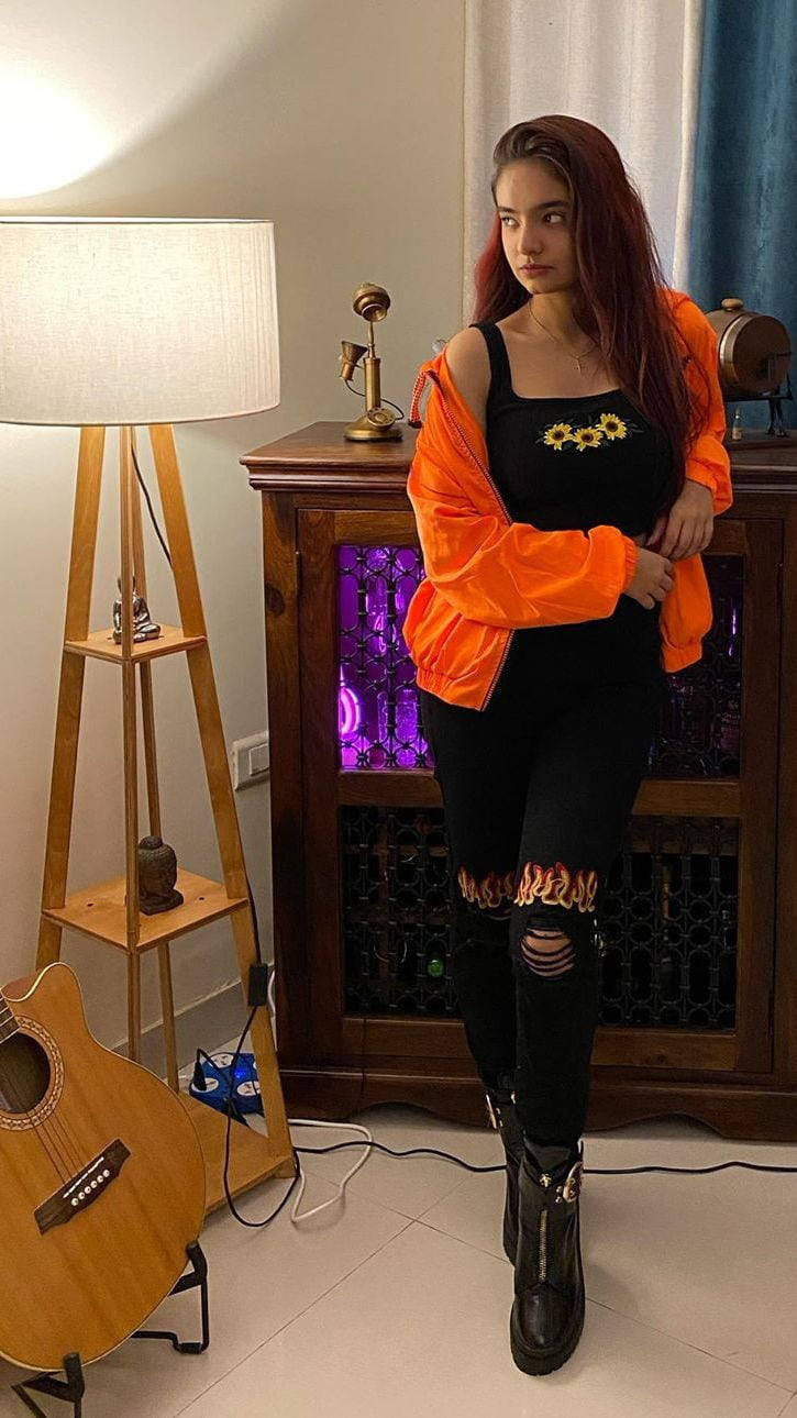 Anushka Sen, bright orange jacket, black sunflower top, HD Phone Wallpaper