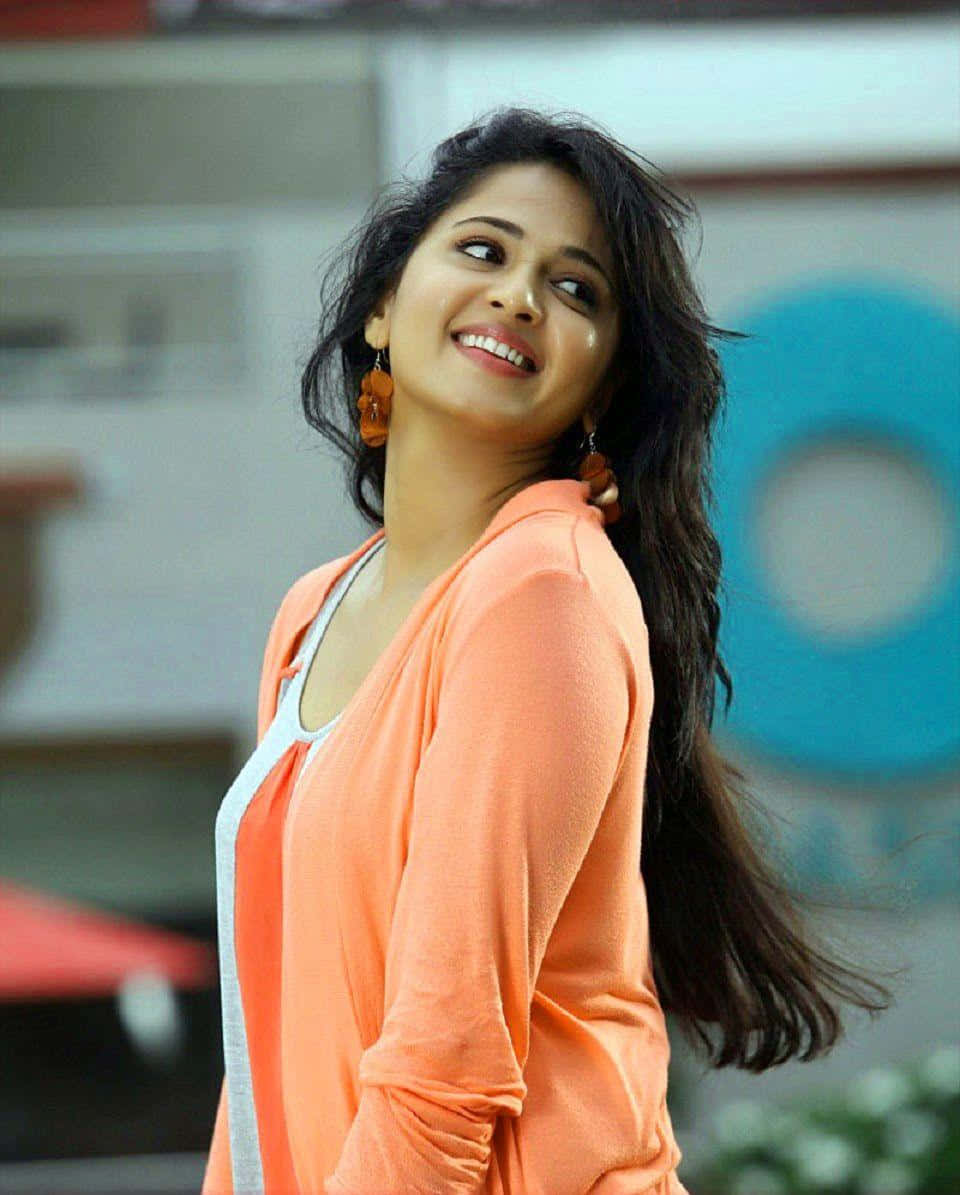 Anushka Shetty, orange cardigan, long dark hair, SD Phone Wallpaper