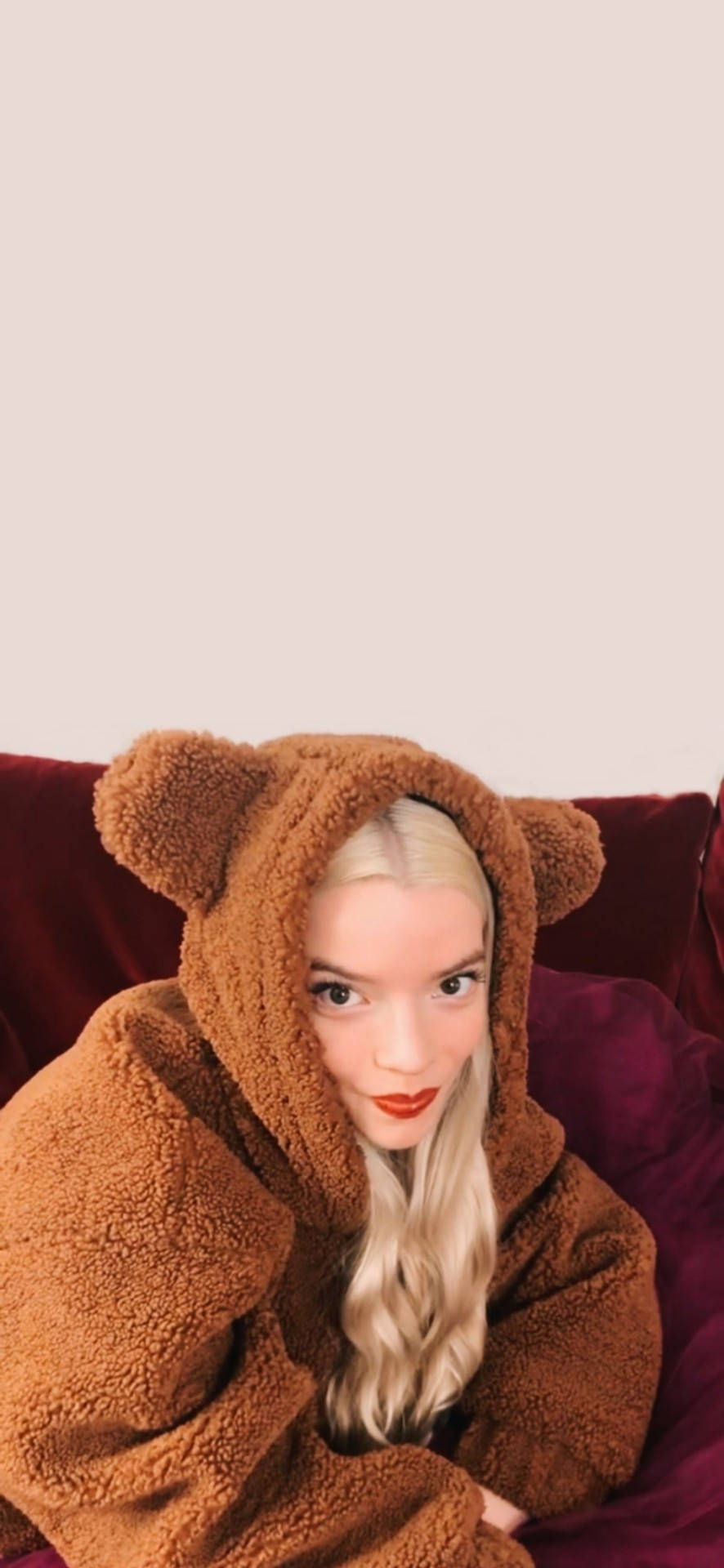 Anya Taylor-Joy, brown teddy bear onesie, plush red couch, Full HD Phone Wallpaper