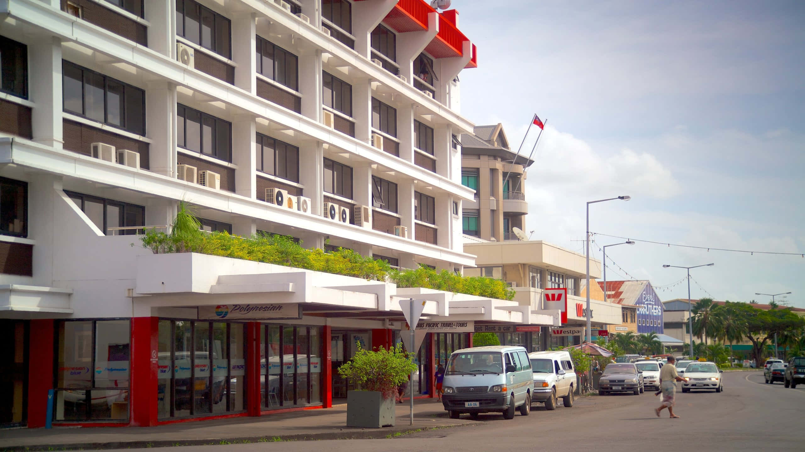 Apia, bright white hotel, red accents, 2K Desktop Wallpaper