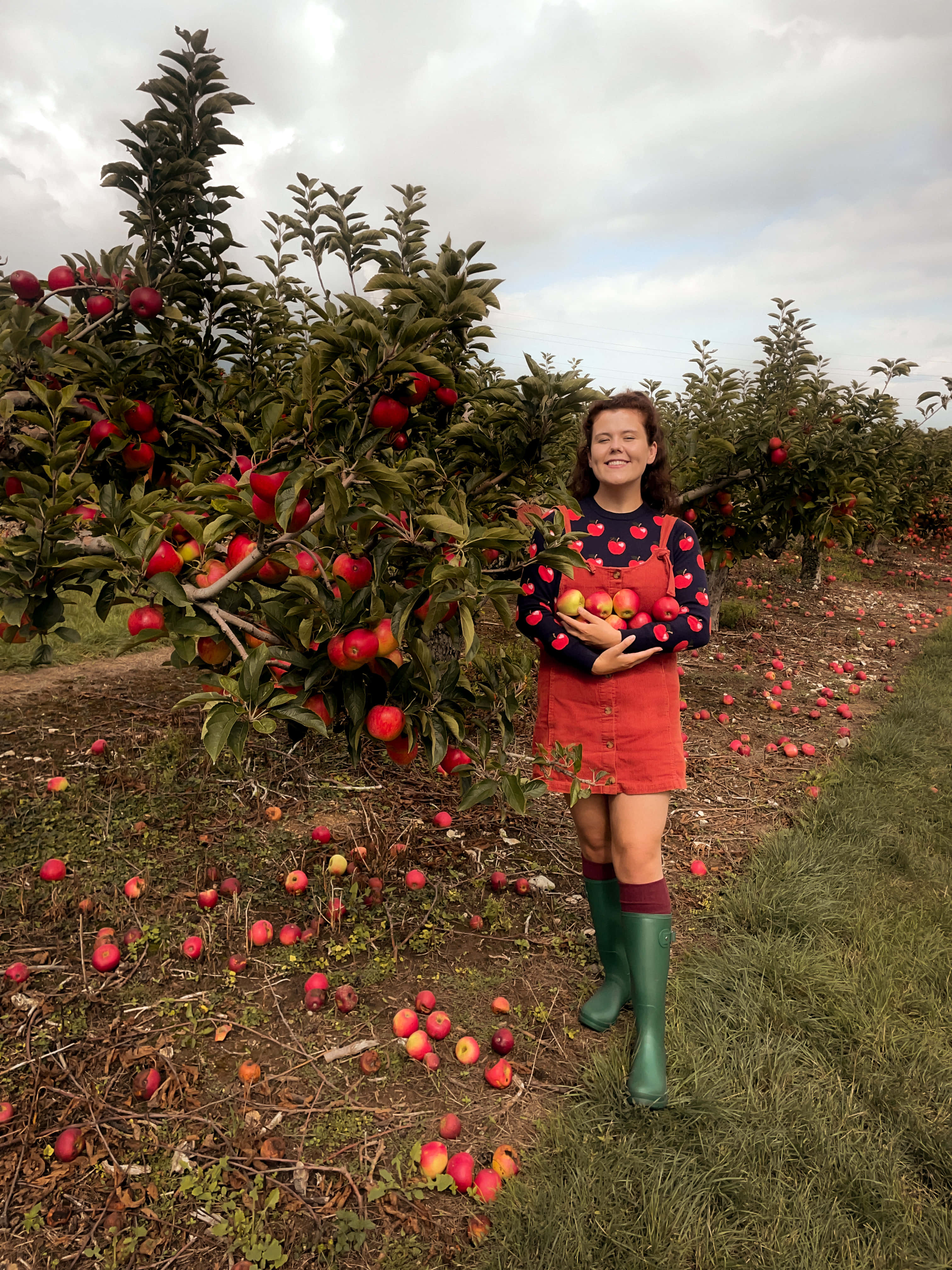 blooming apple orchard, sunset, girl in red overalls and green boots, 4K Phone Wallpaper
