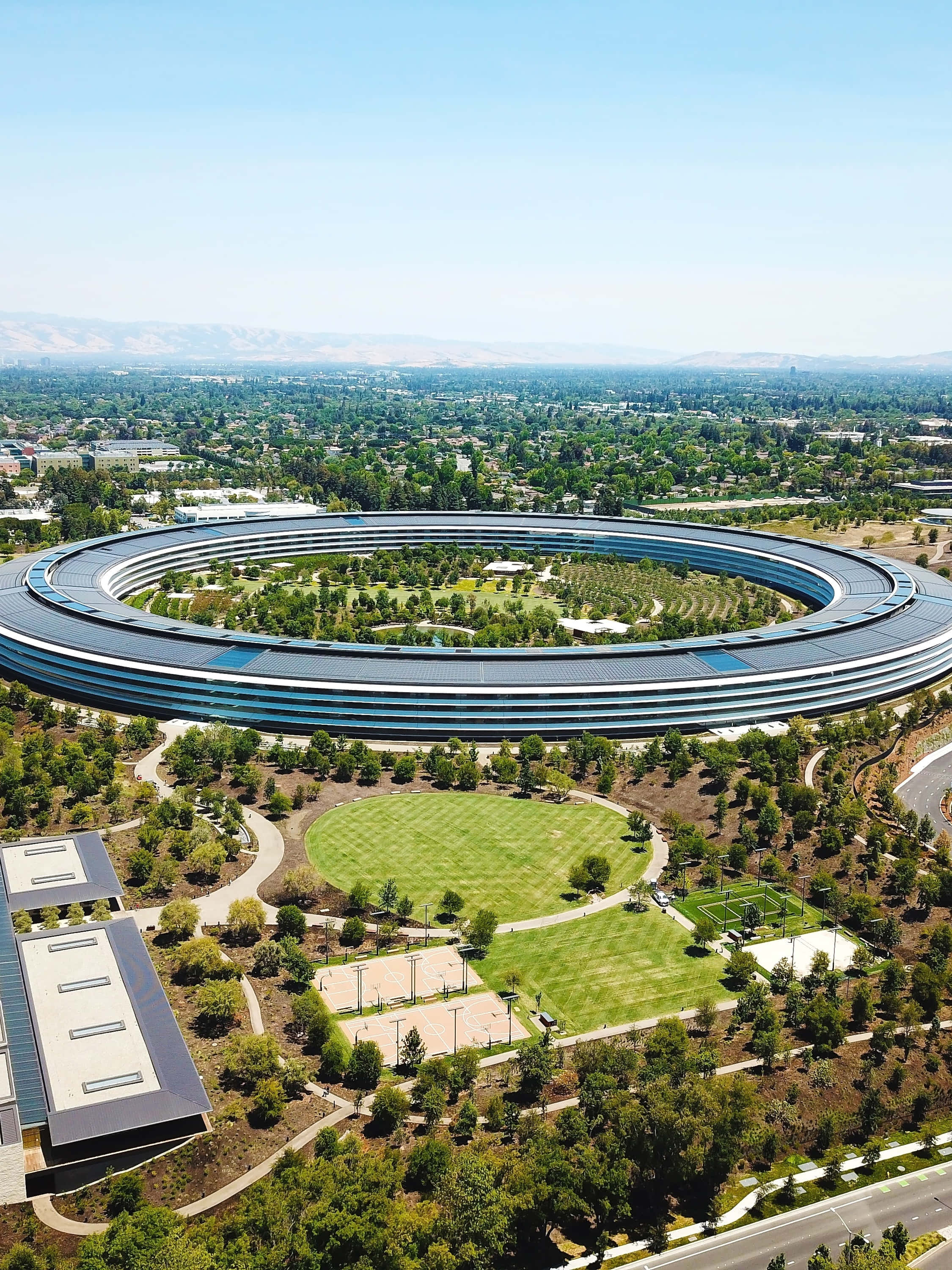 Apple Park, circular glass building, lush green lawns, 2K Phone Wallpaper