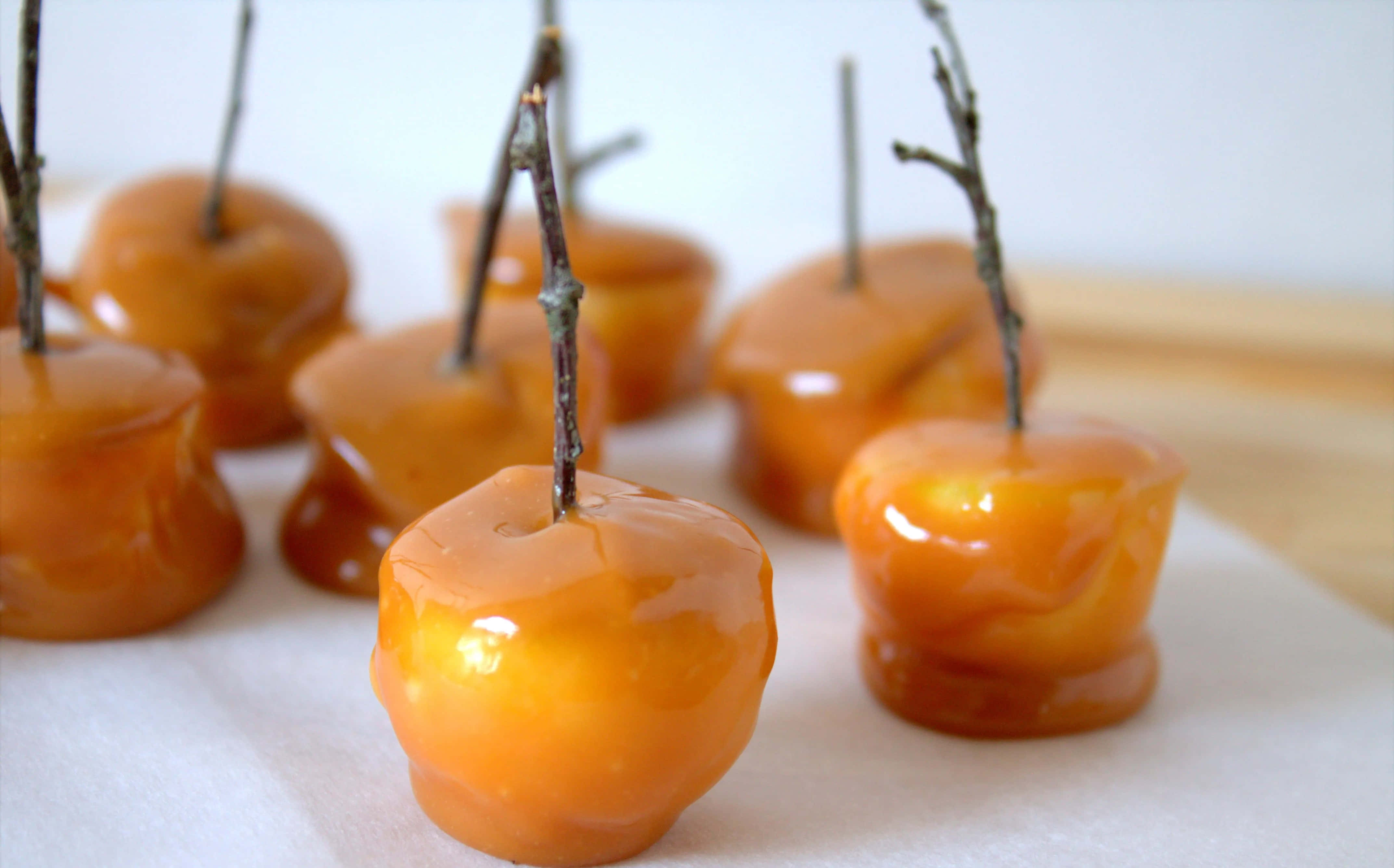 caramel apples, twig stems, parchment paper, 4K Desktop Wallpaper