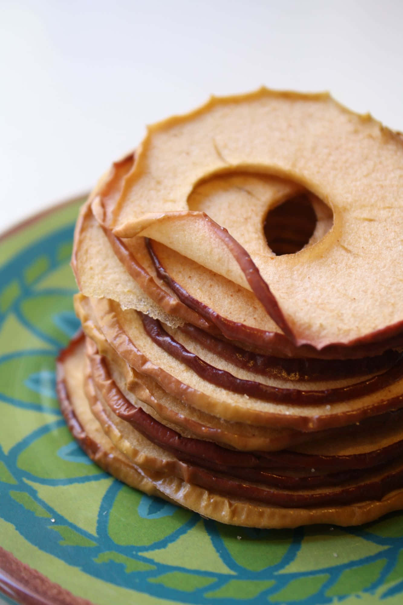 dried apple rings, caramelized edges, colorful patterned plate, Full HD Phone Wallpaper