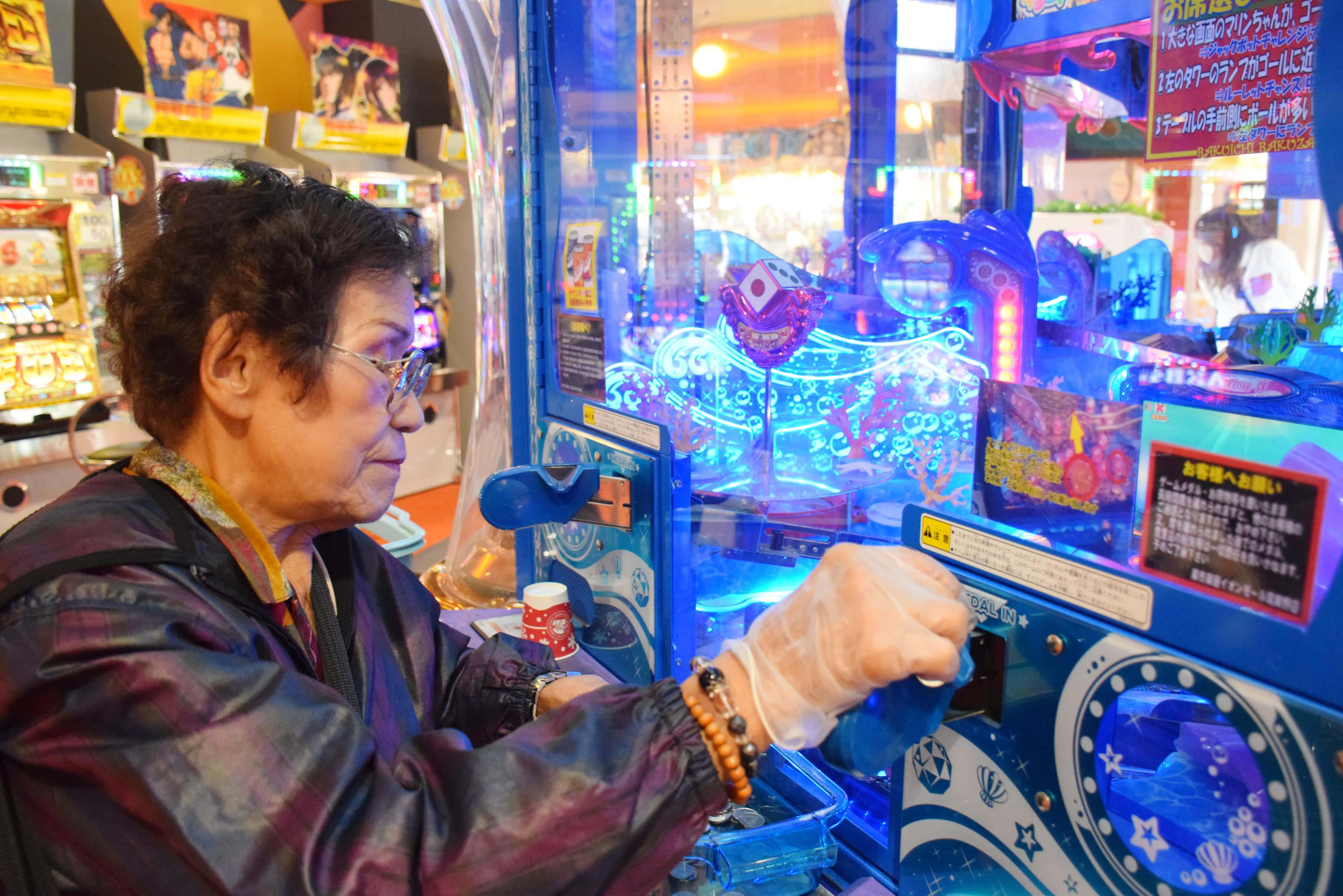 arcade, glowing blue claw machine, elderly woman, 4K Desktop Wallpaper