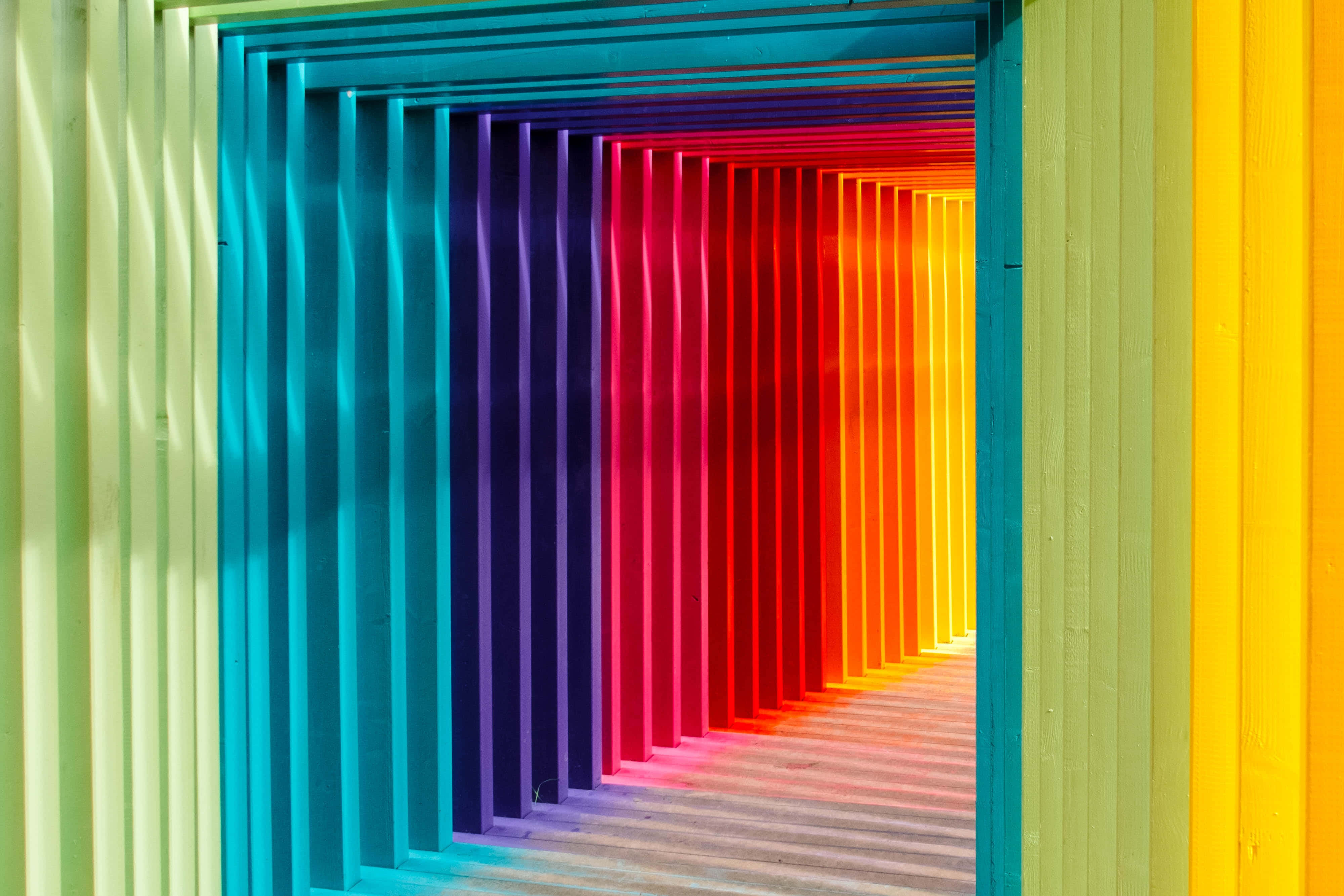 multifaceted rainbow walkway, rainbow-colored wooden tunnel, vertical slats, 4K Desktop Wallpaper