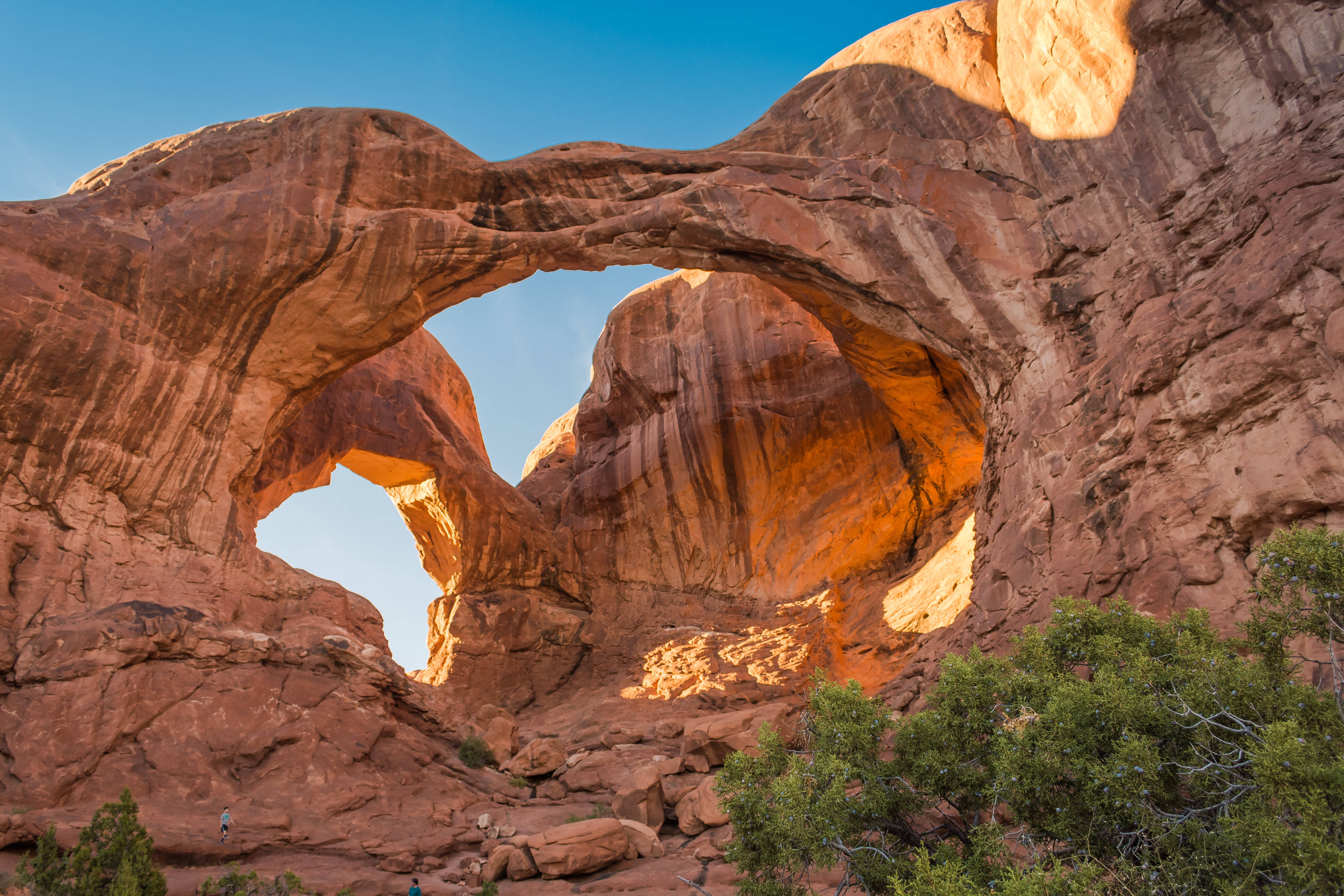 Arches National Park, double sandstone arch, warm golden light, 5K Desktop Wallpaper