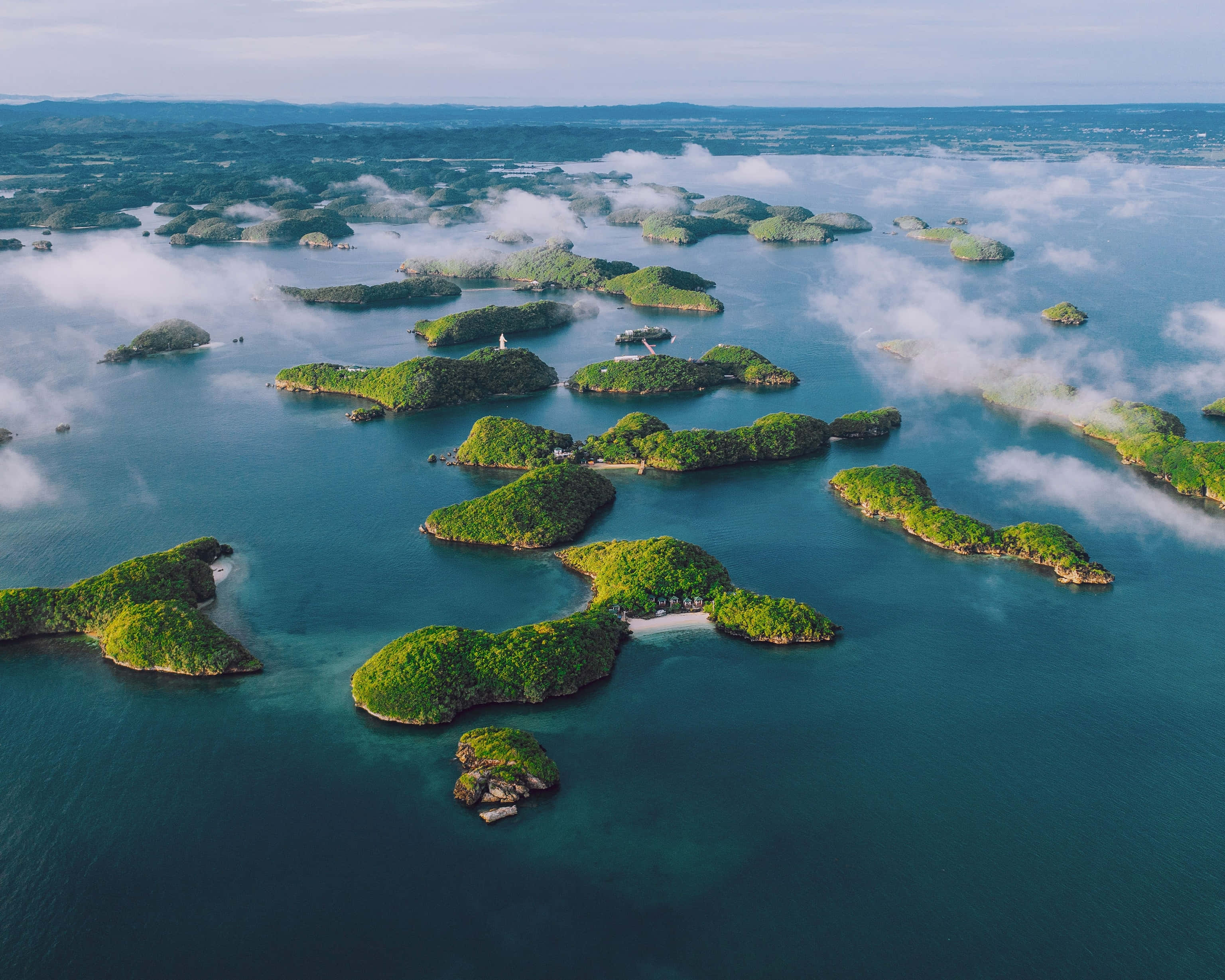 Misty Archipelago, aerial view, lush green islands, 2K Desktop Wallpaper