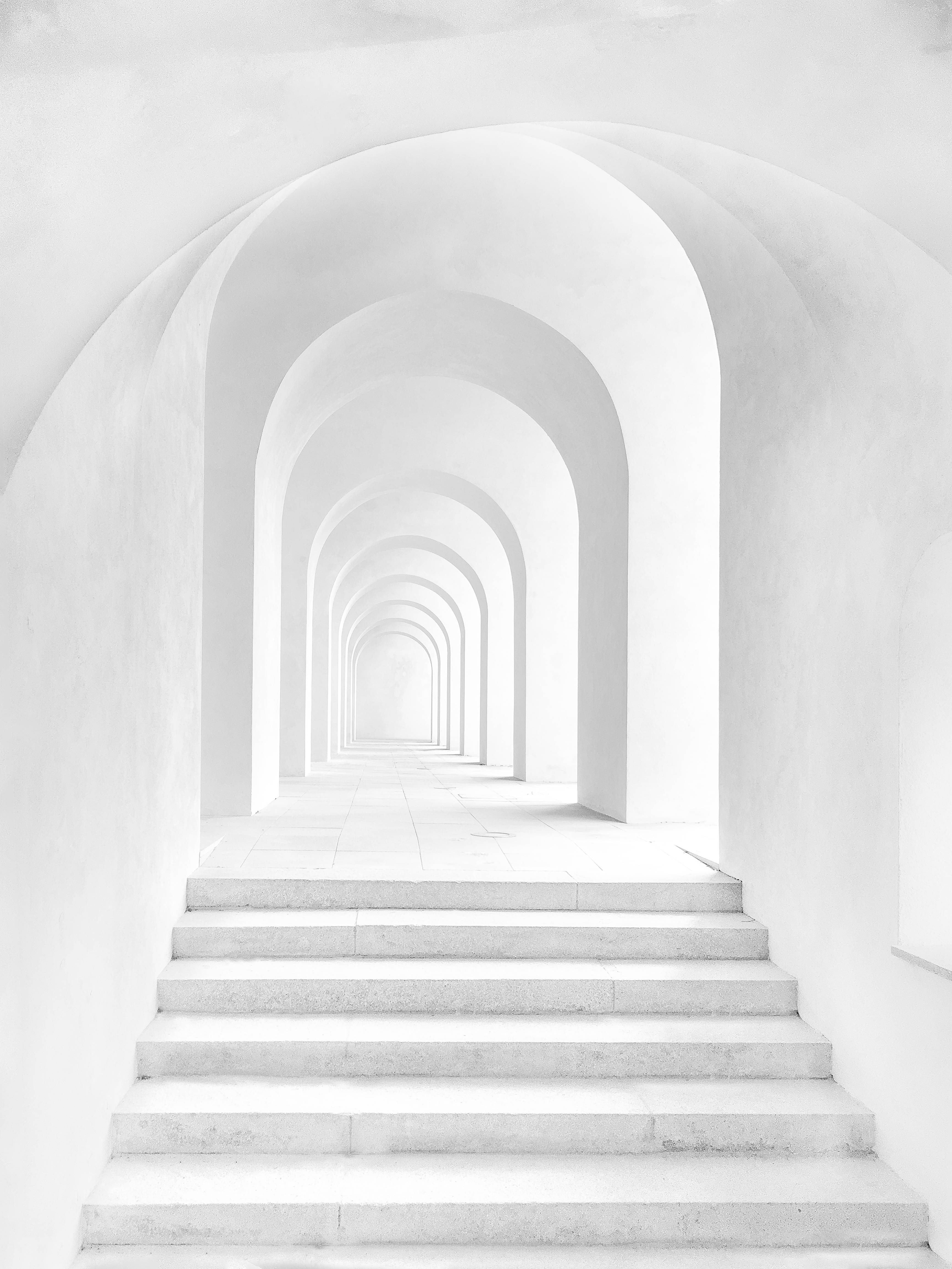 white castle hallway, serene white staircase, long tunnel of repeating arches, 4K Phone Wallpaper