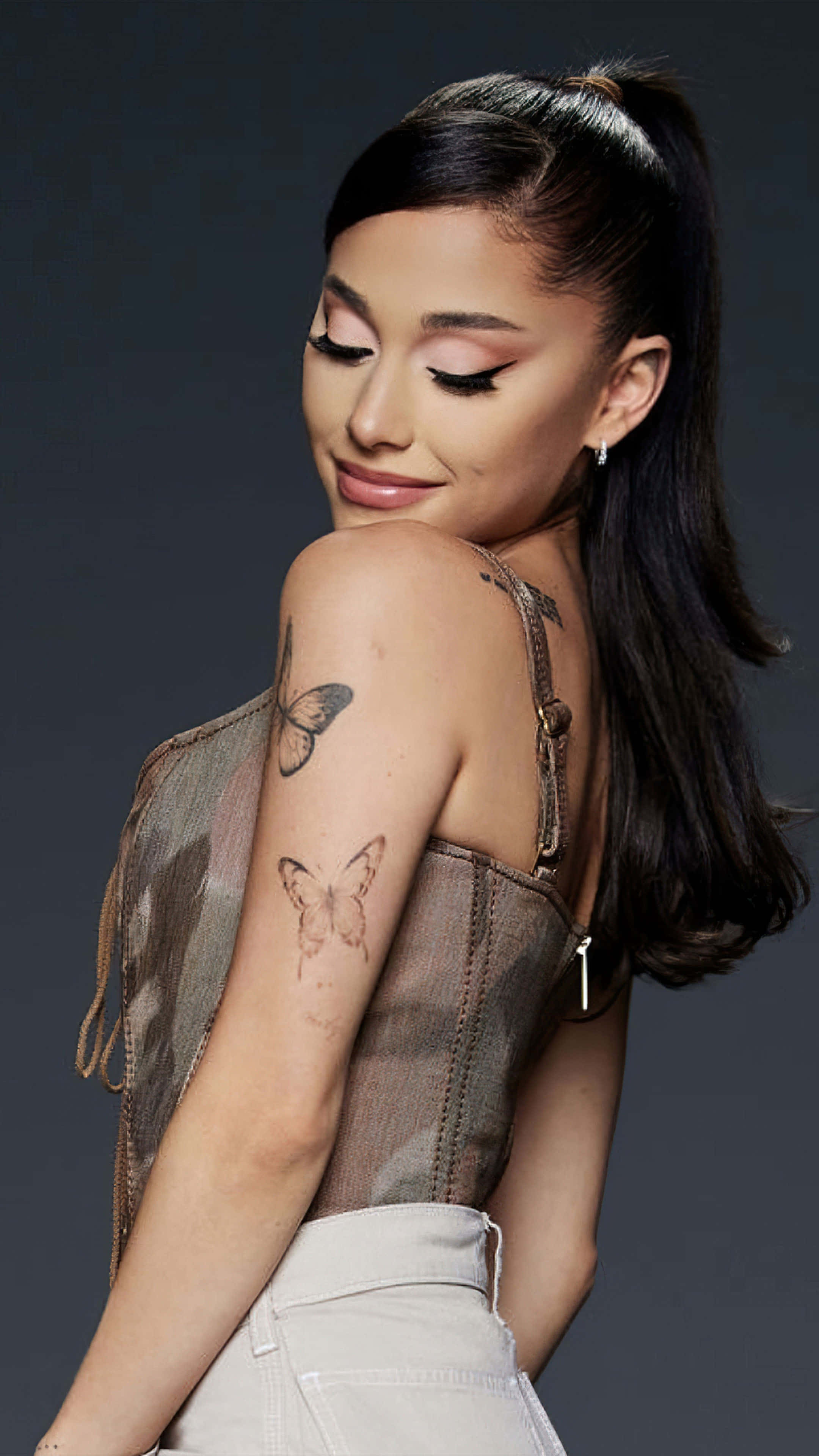 Ariana Grande, butterfly tattoos, dark studio backdrop, 4K Phone Wallpaper