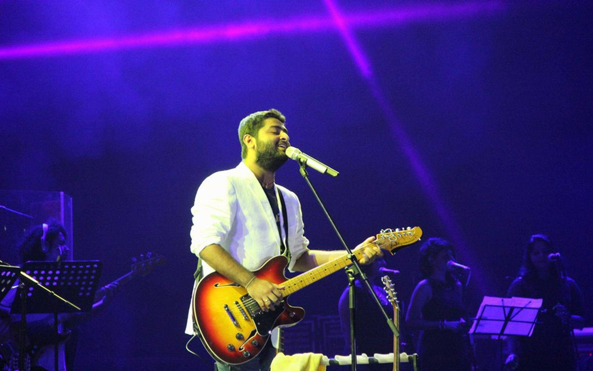 Arijit Singh, sunburst electric guitar, vibrant purple stage lights, Full HD Desktop Wallpaper