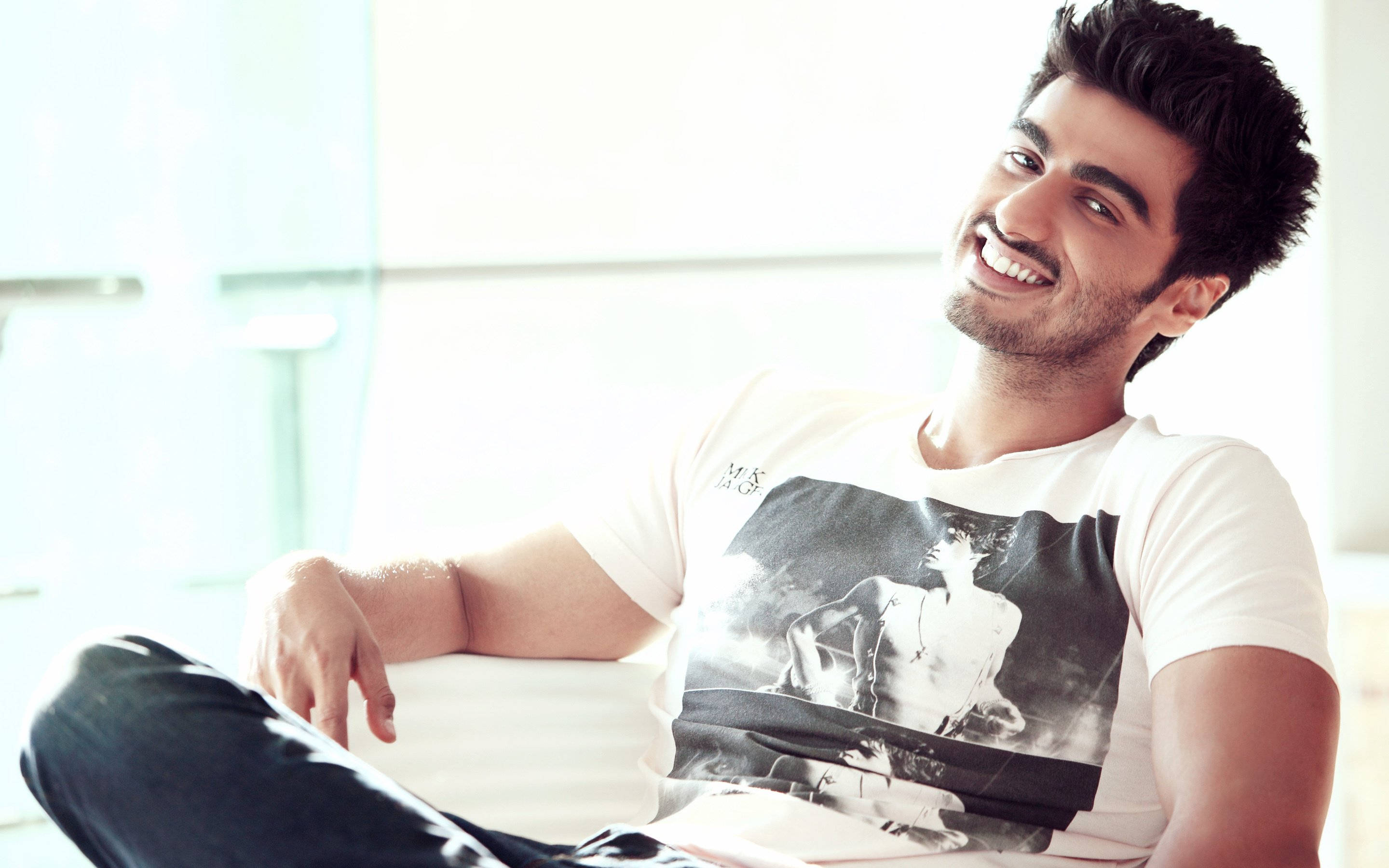 Arjun Kapoor, white couch, bright modern room, 2K Desktop Wallpaper