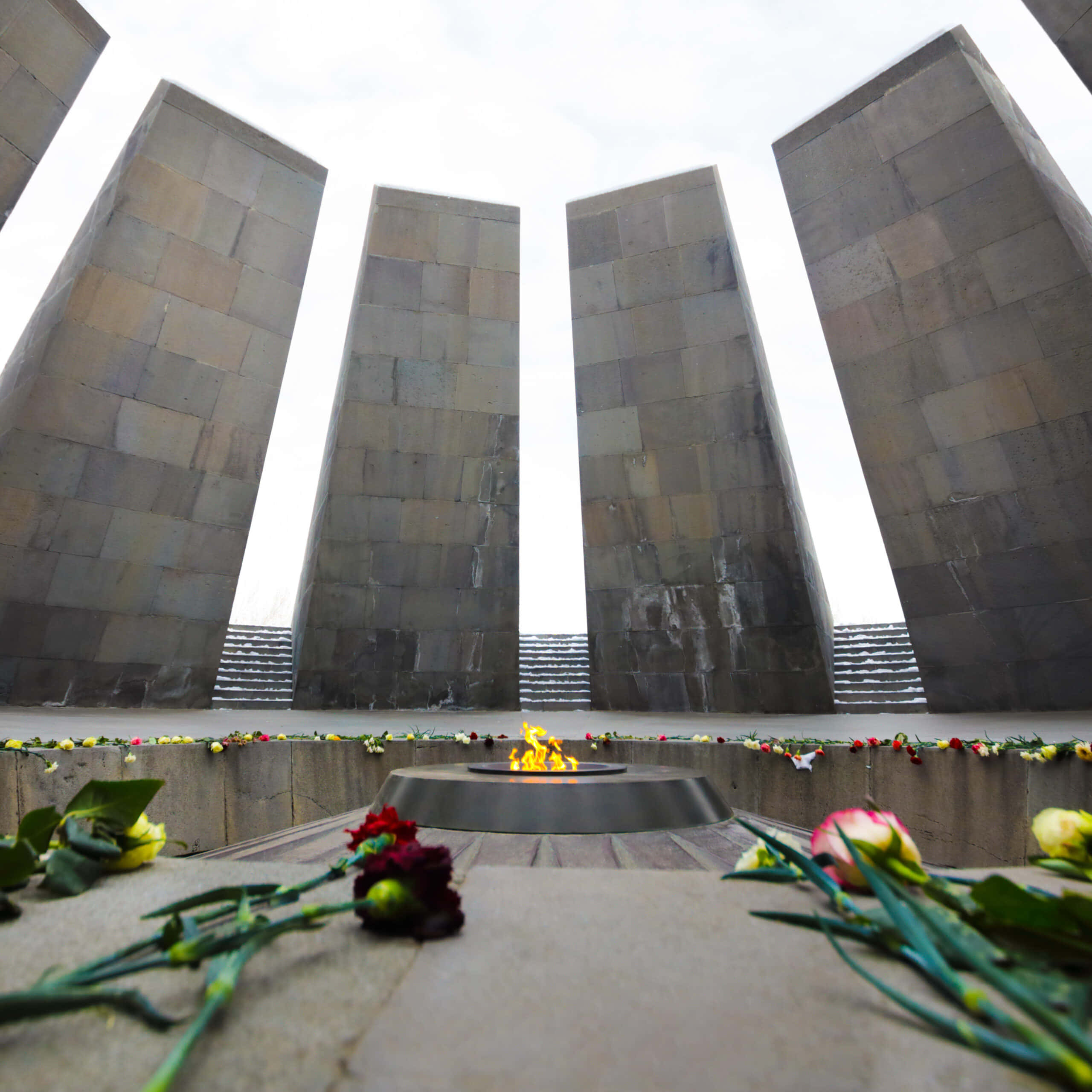 Armenian Genocide Memorial, eternal flame, towering stone pillars, 2K Desktop Wallpaper