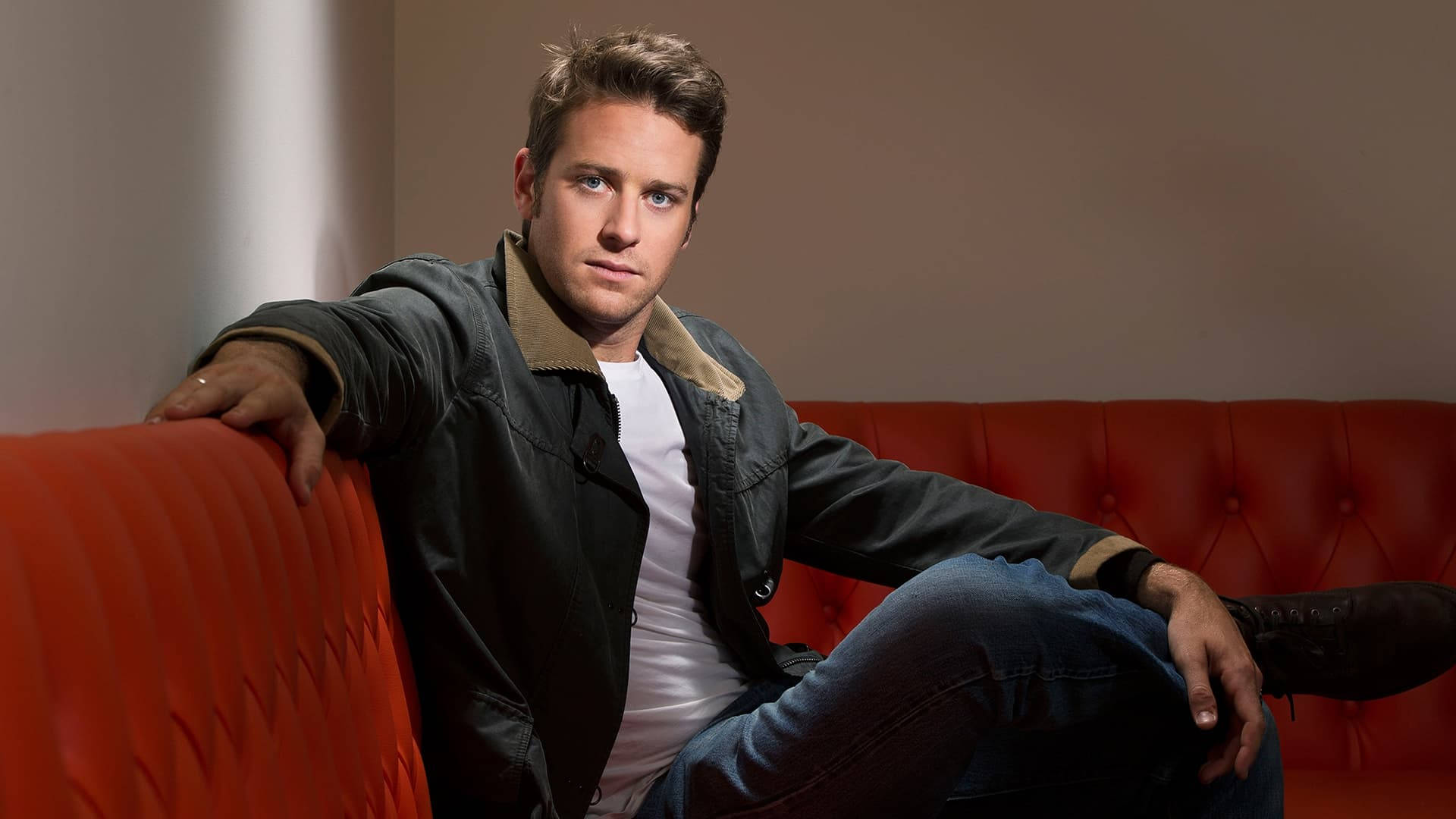 Armie Hammer, orange couch, black jacket, Full HD Desktop Wallpaper