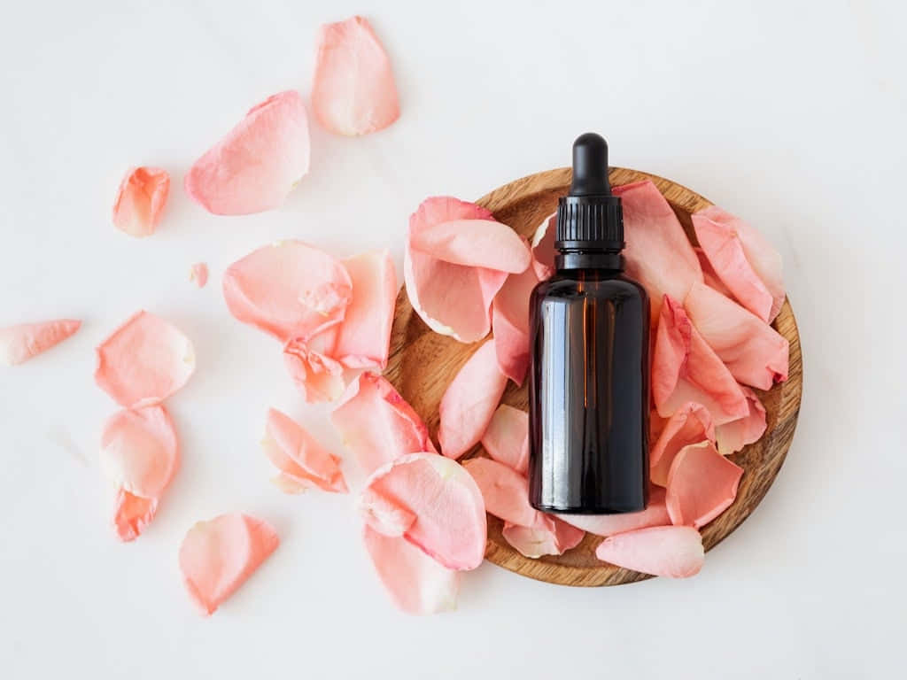 dark amber glass dropper bottle, wooden plate, soft pink rose petals, SD Desktop Wallpaper