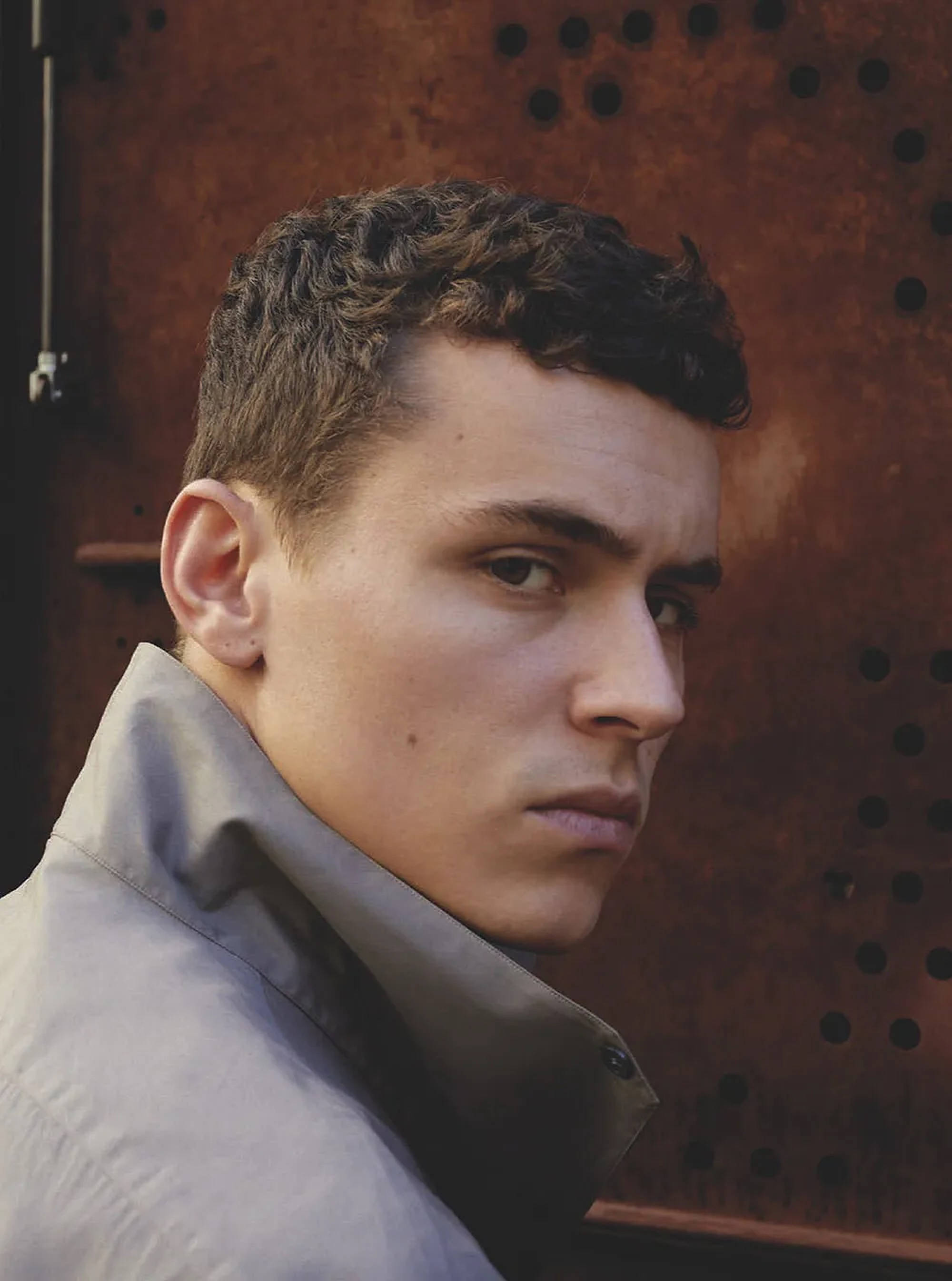 Aron Piper, curly dark hair, serious expression, 2K Phone Wallpaper
