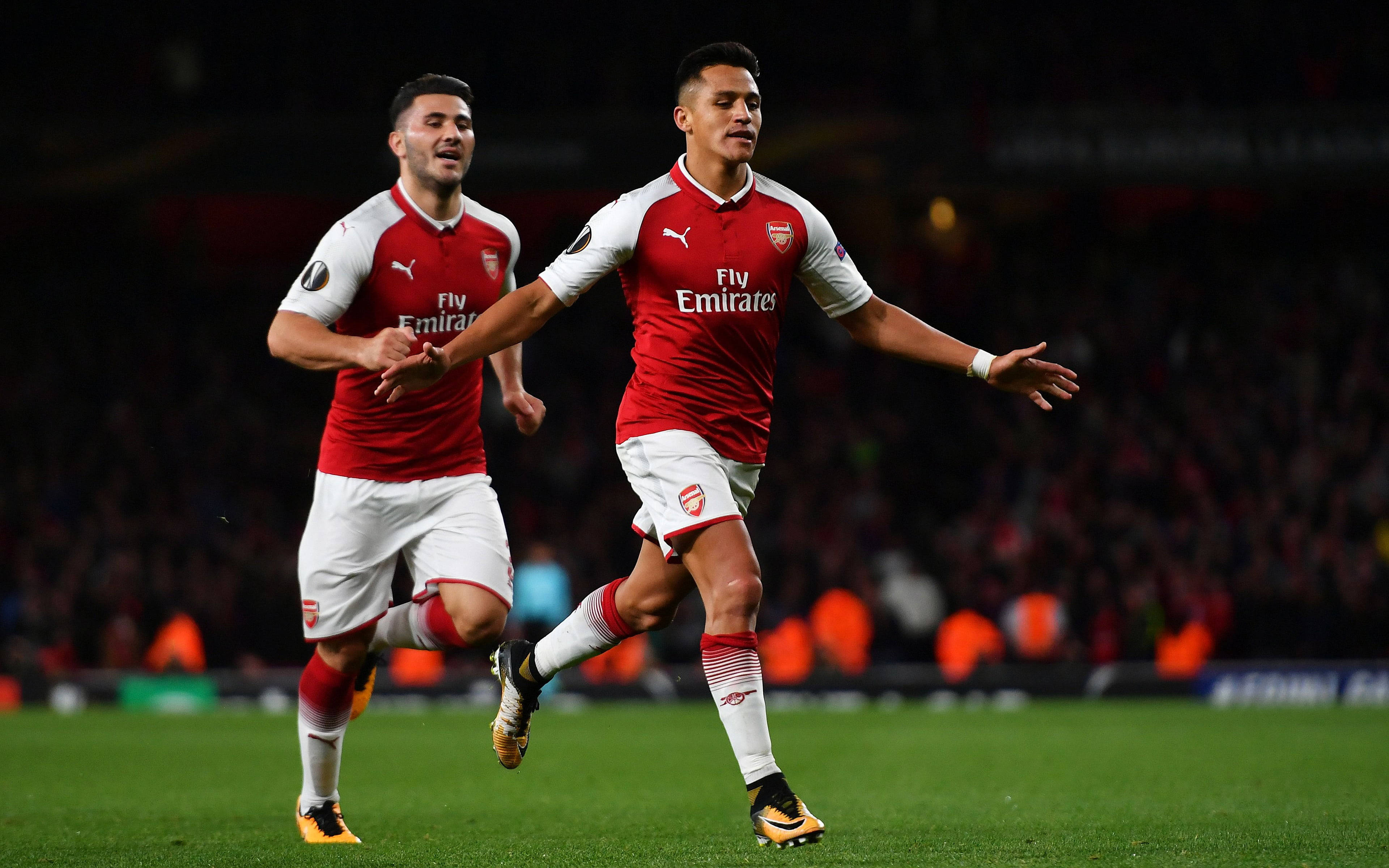 Arsenal FC, red and white kits, vibrant green pitch, 4K Desktop Wallpaper