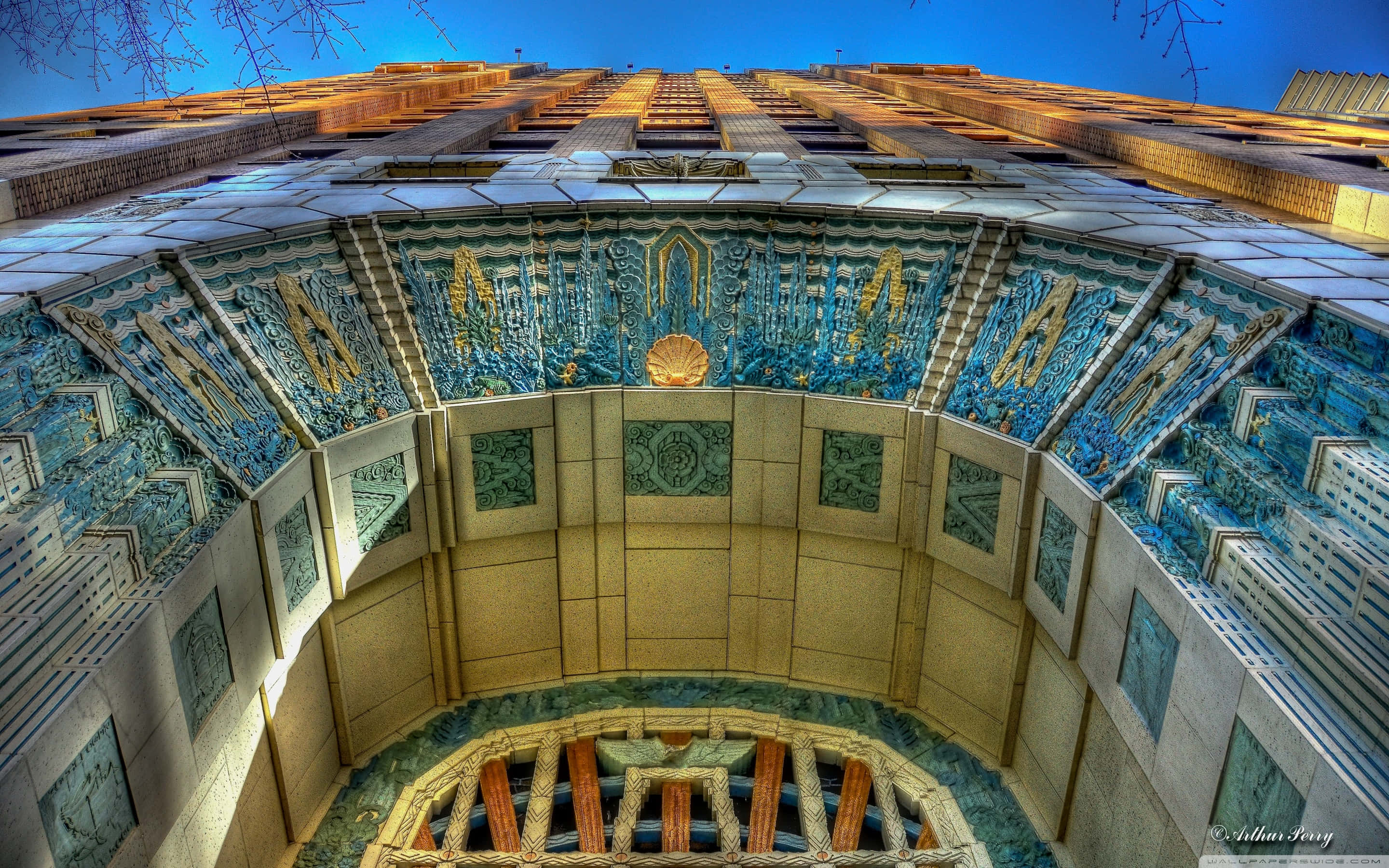 Art Deco building facade, blue and gold tilework, deep blue sky, 2K Desktop Wallpaper