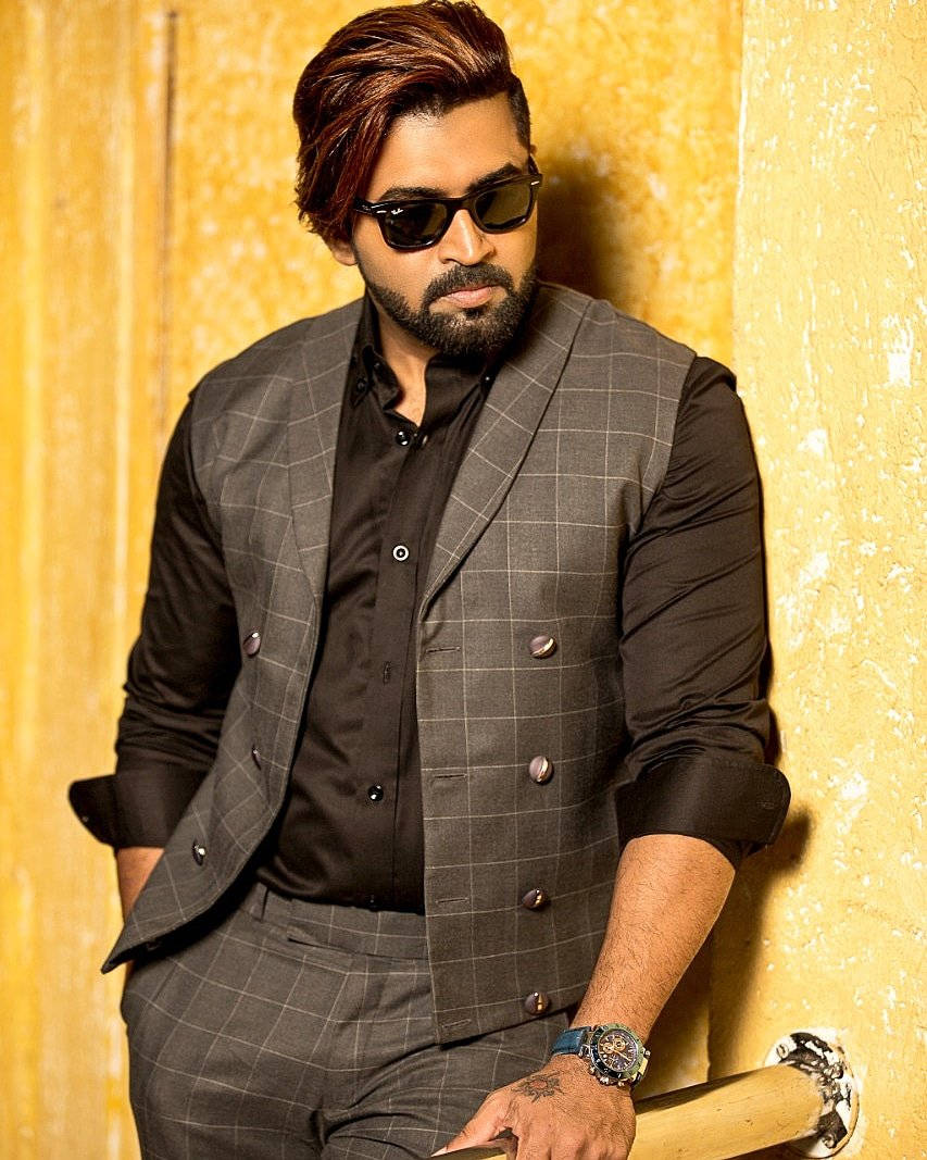 Arun Vijay, checkered suit, textured yellow wall, SD Phone Wallpaper