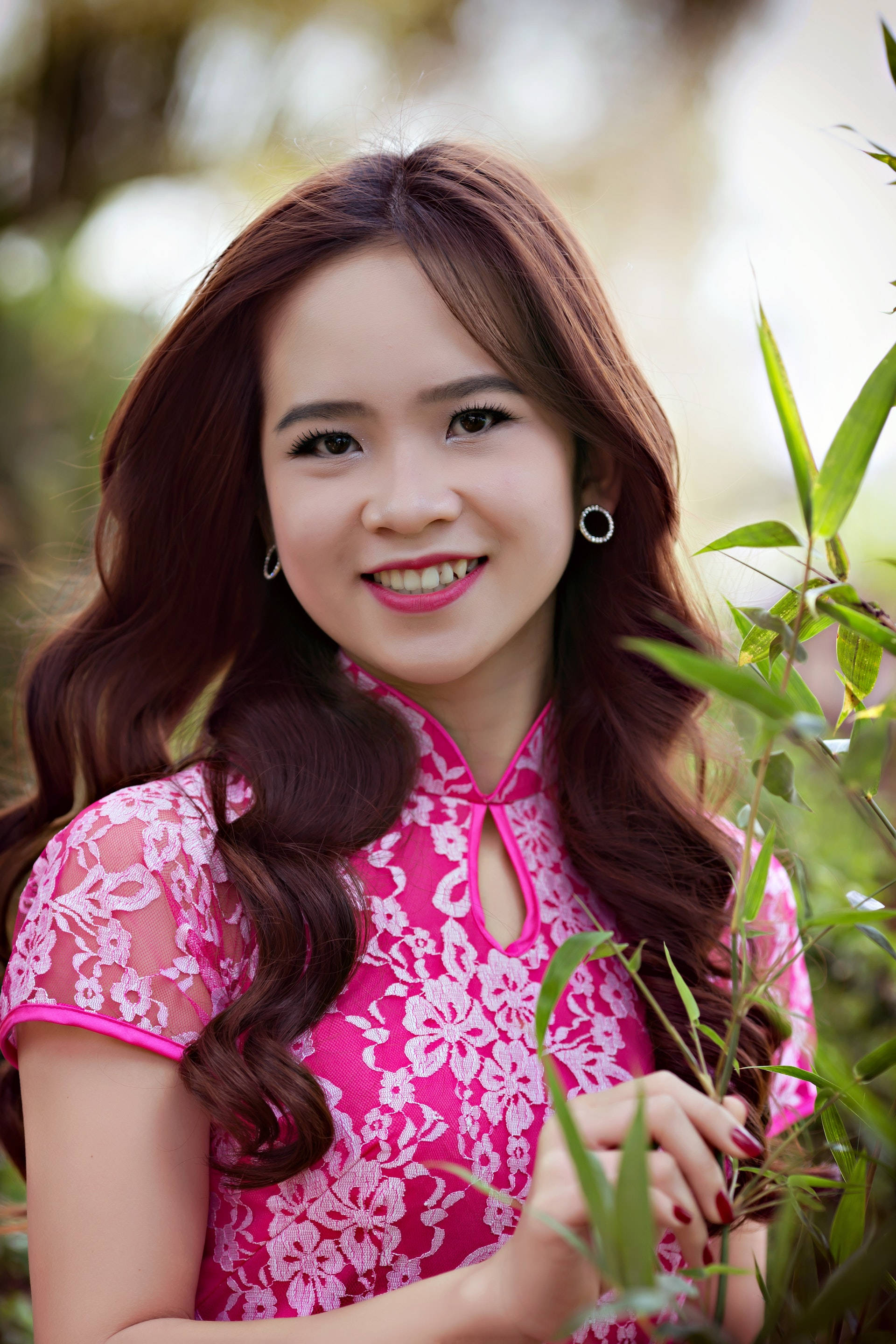 traditional Chinese qipao, vibrant pink floral ao dai, lush green bamboo, 2K Phone Wallpaper