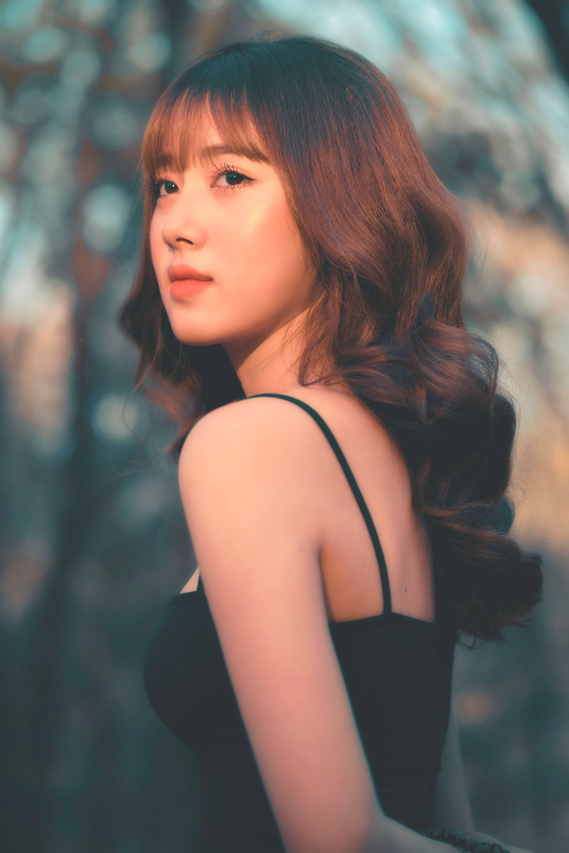 Asian woman, black spaghetti strap, wavy brown hair, 2K Phone Wallpaper