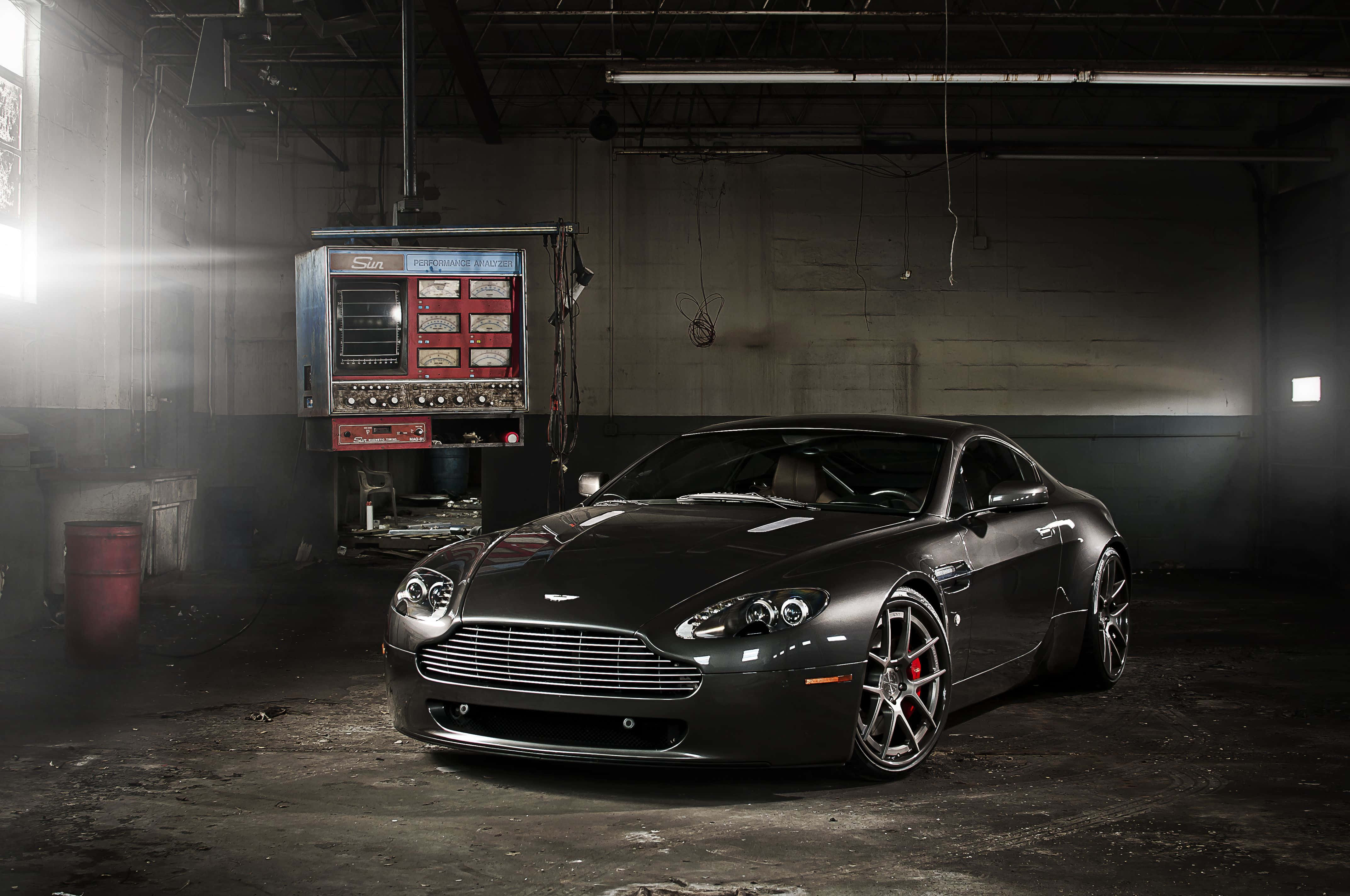Aston Martin V12 Vantage, matte black, dramatic spotlight, 4K Desktop Wallpaper