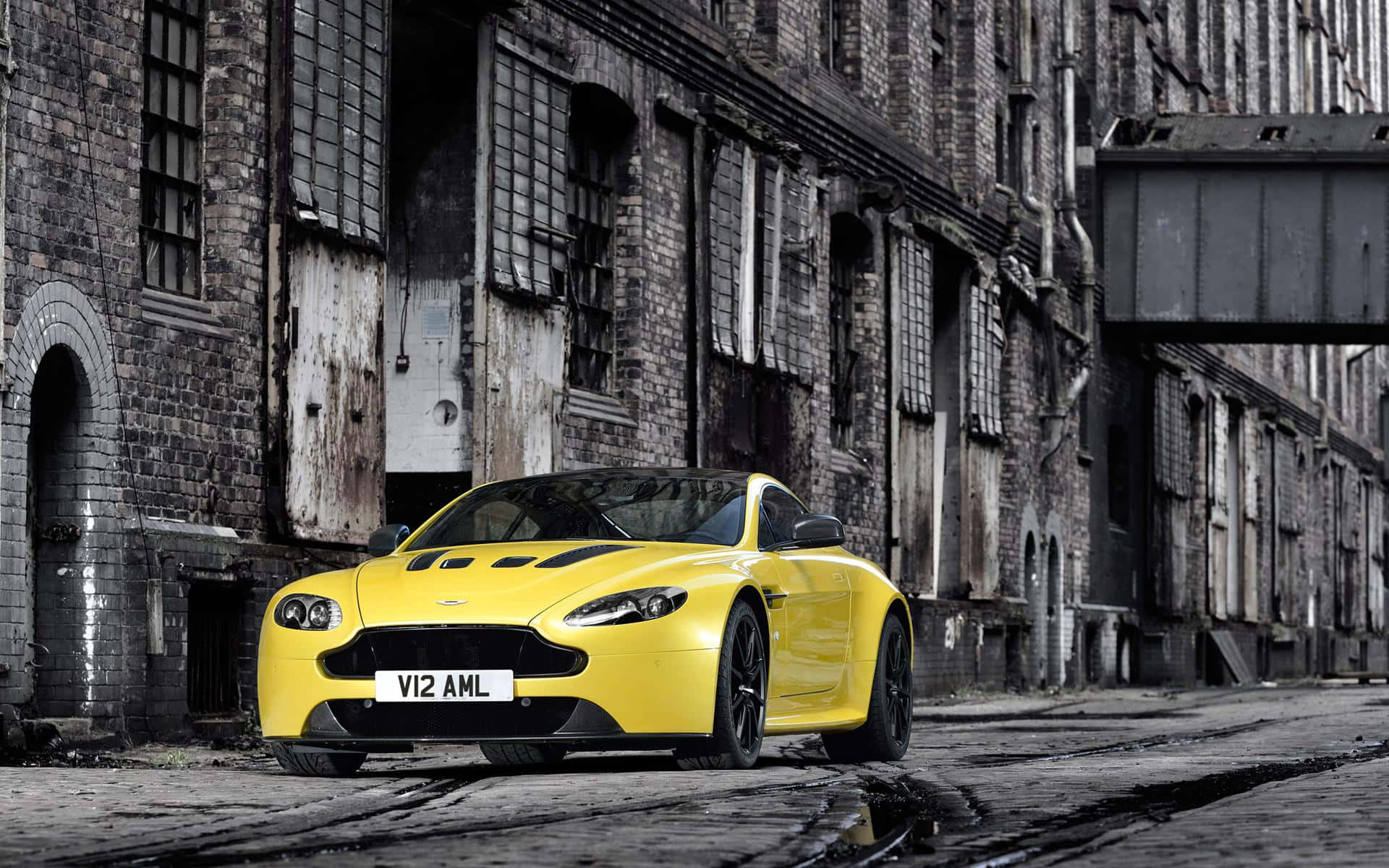 Aston Martin V12 Vantage, vibrant yellow, wet cobblestone street, Full HD Desktop Wallpaper