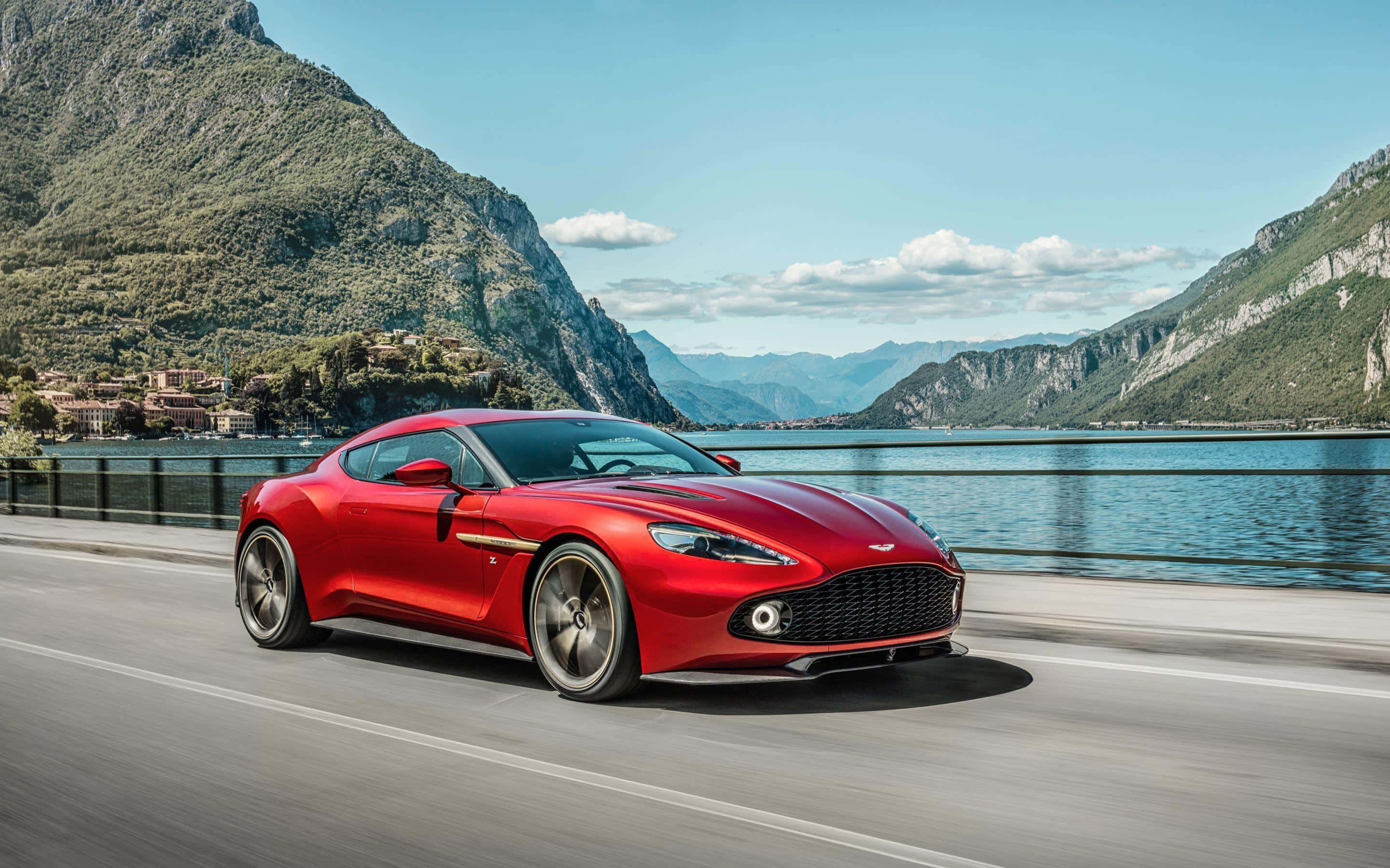 Aston Martin Vanquish, vibrant red, lakeside road, 2K Desktop Wallpaper