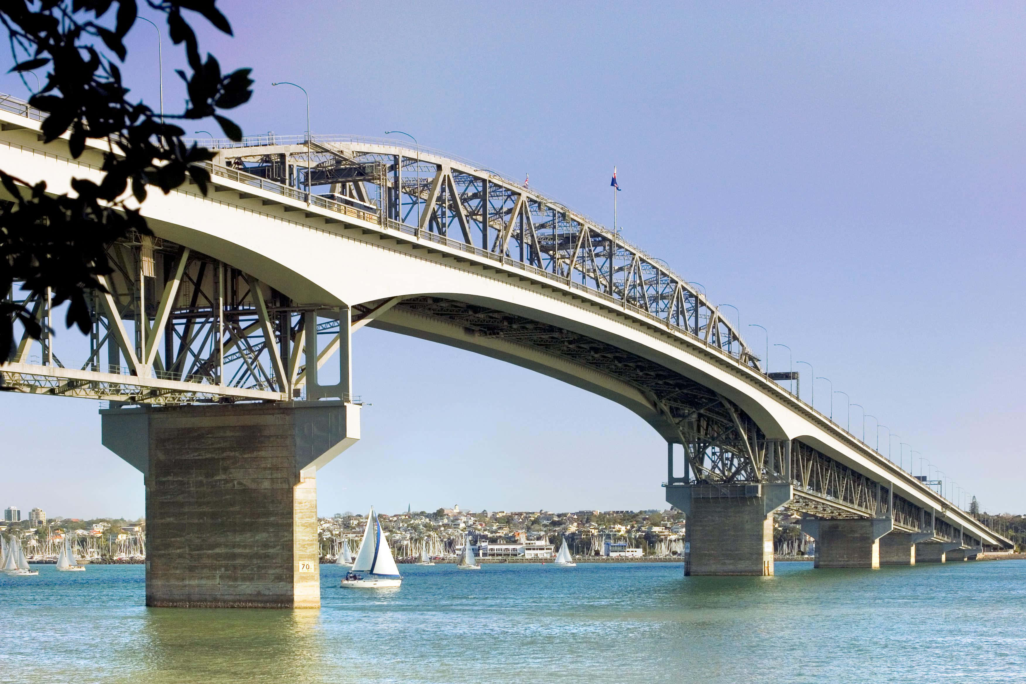 Auckland Harbour Bridge, sunny day, calm blue harbor, 2K Desktop Wallpaper