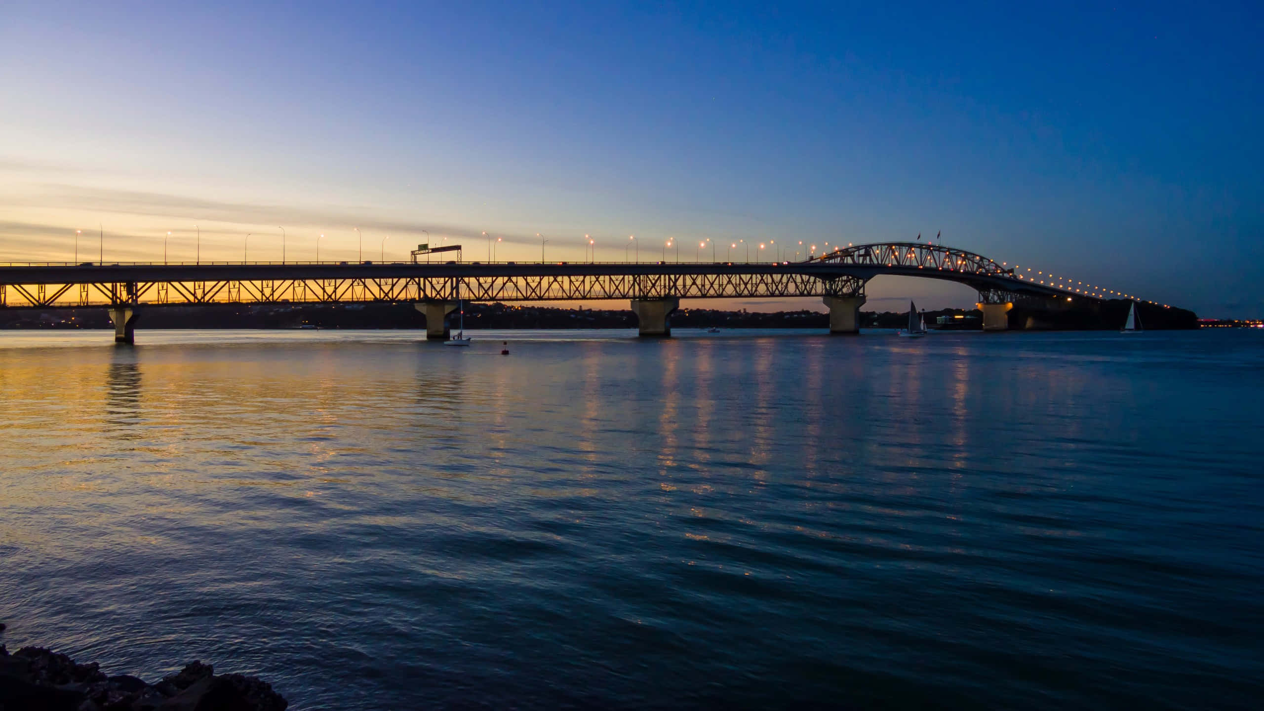 Auckland Harbour Bridge, dusk, calm waters, 2K Desktop Wallpaper