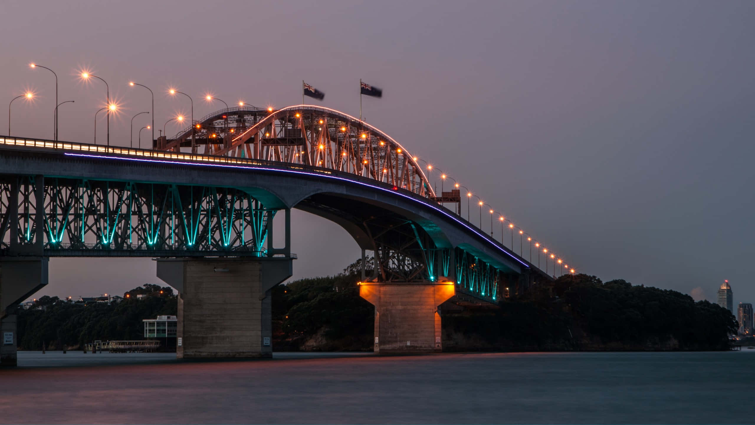 Auckland Harbour Bridge, twilight illumination, teal and amber lights, 2K Desktop Wallpaper