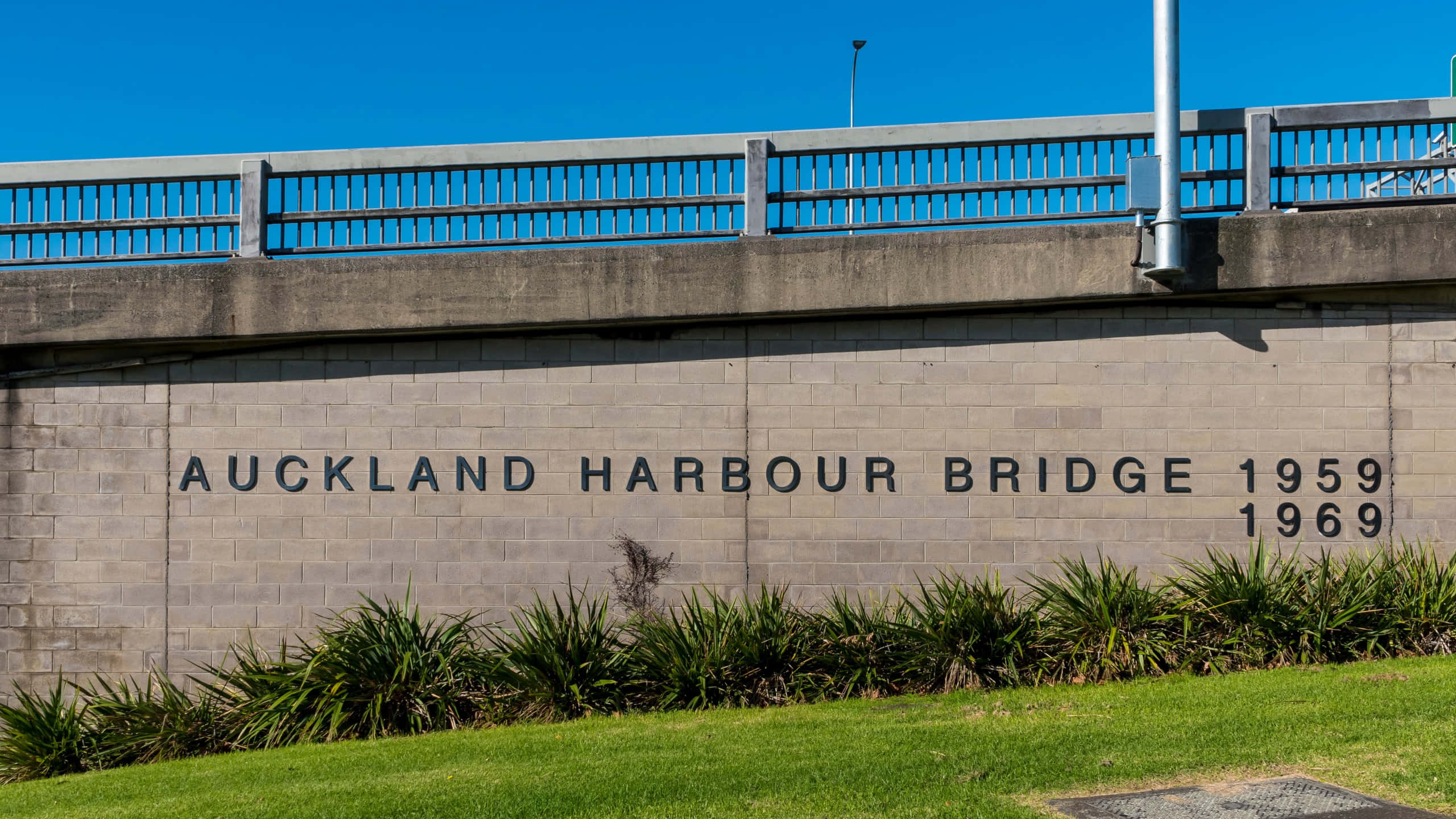 Auckland Harbour Bridge, concrete abutment, engraved text, 2K Desktop Wallpaper