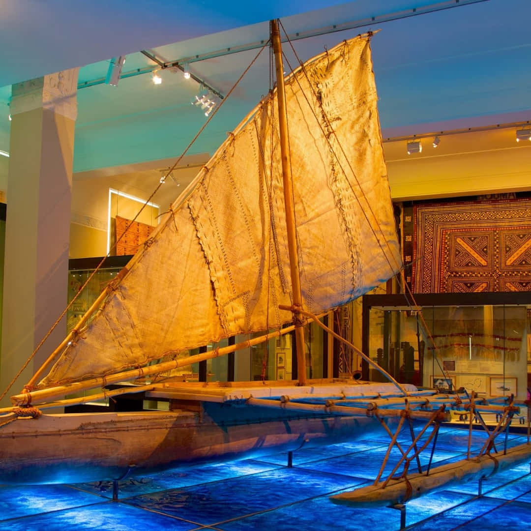 traditional double-hulled Polynesian sailing canoe, weathered sail, museum lights, SD Desktop Wallpaper