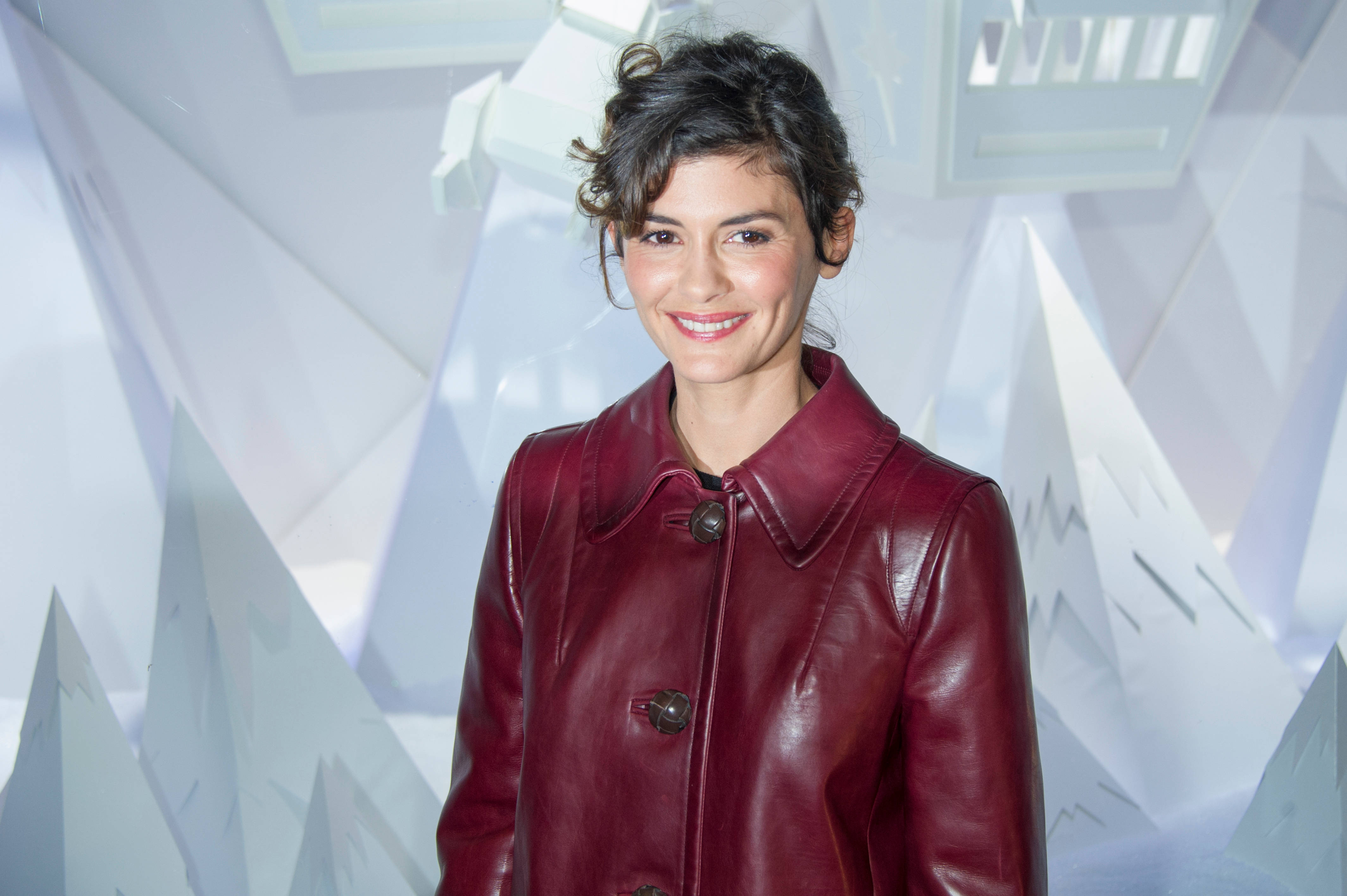 Audrey Tautou, glossy burgundy leather coat, white geometric mountain backdrop, 4K Desktop Wallpaper