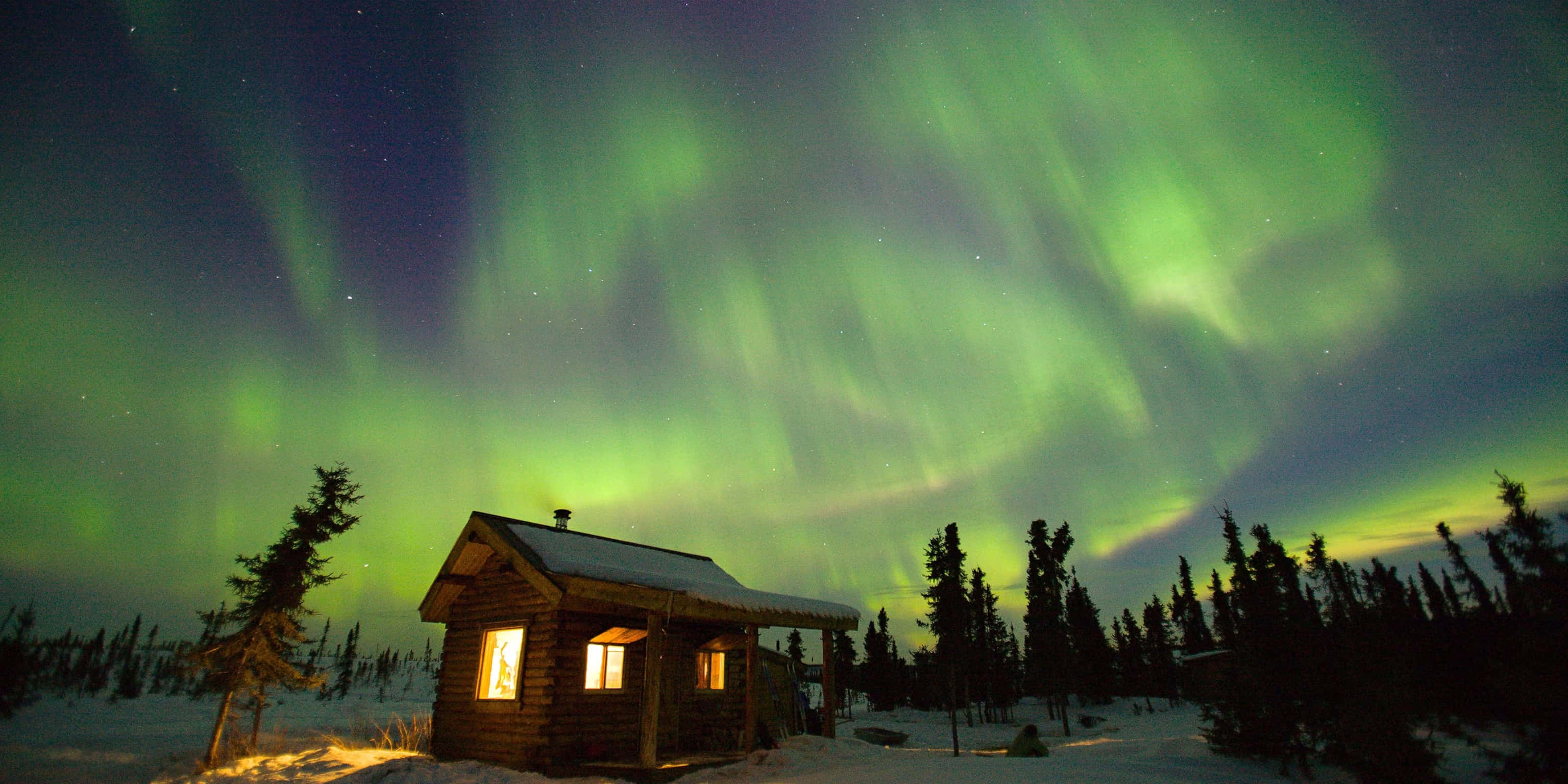 Aurora borealis, wooden cabin, snowy forest night sky, 2K Desktop Wallpaper