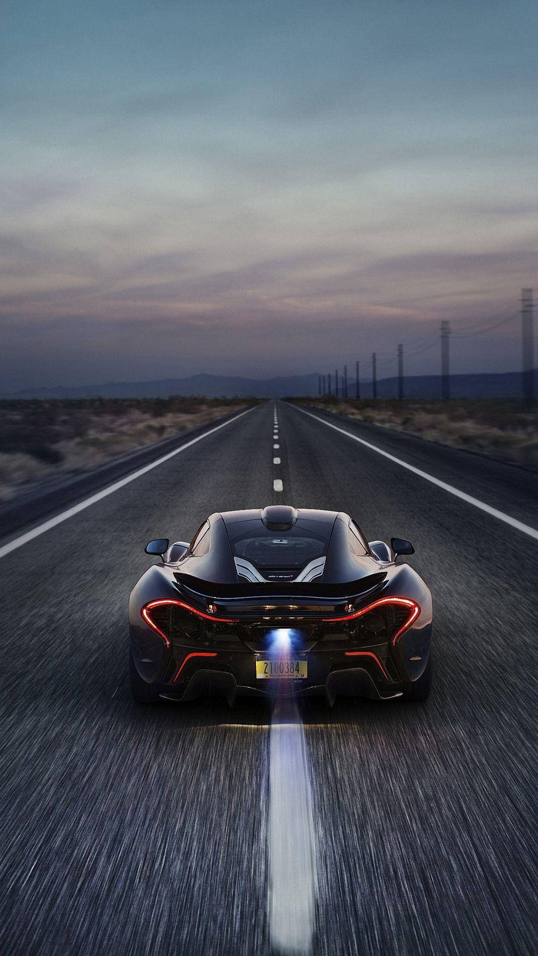 sleek black sports car, desert highway, dusk, Full HD Phone Wallpaper
