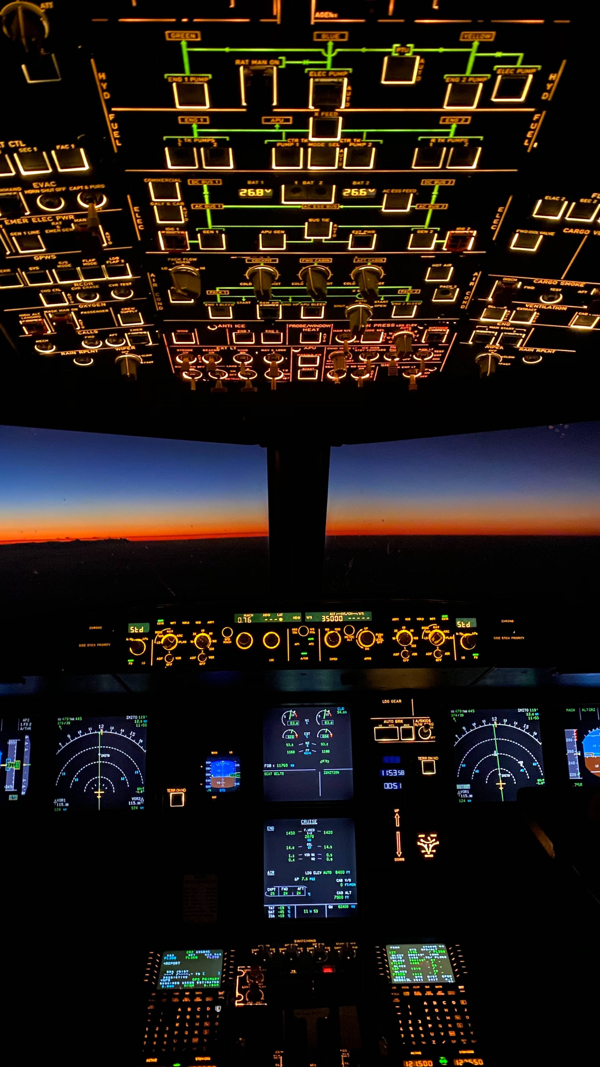 Aviation, glowing instrument panels, fiery orange horizon, 2K Phone Wallpaper