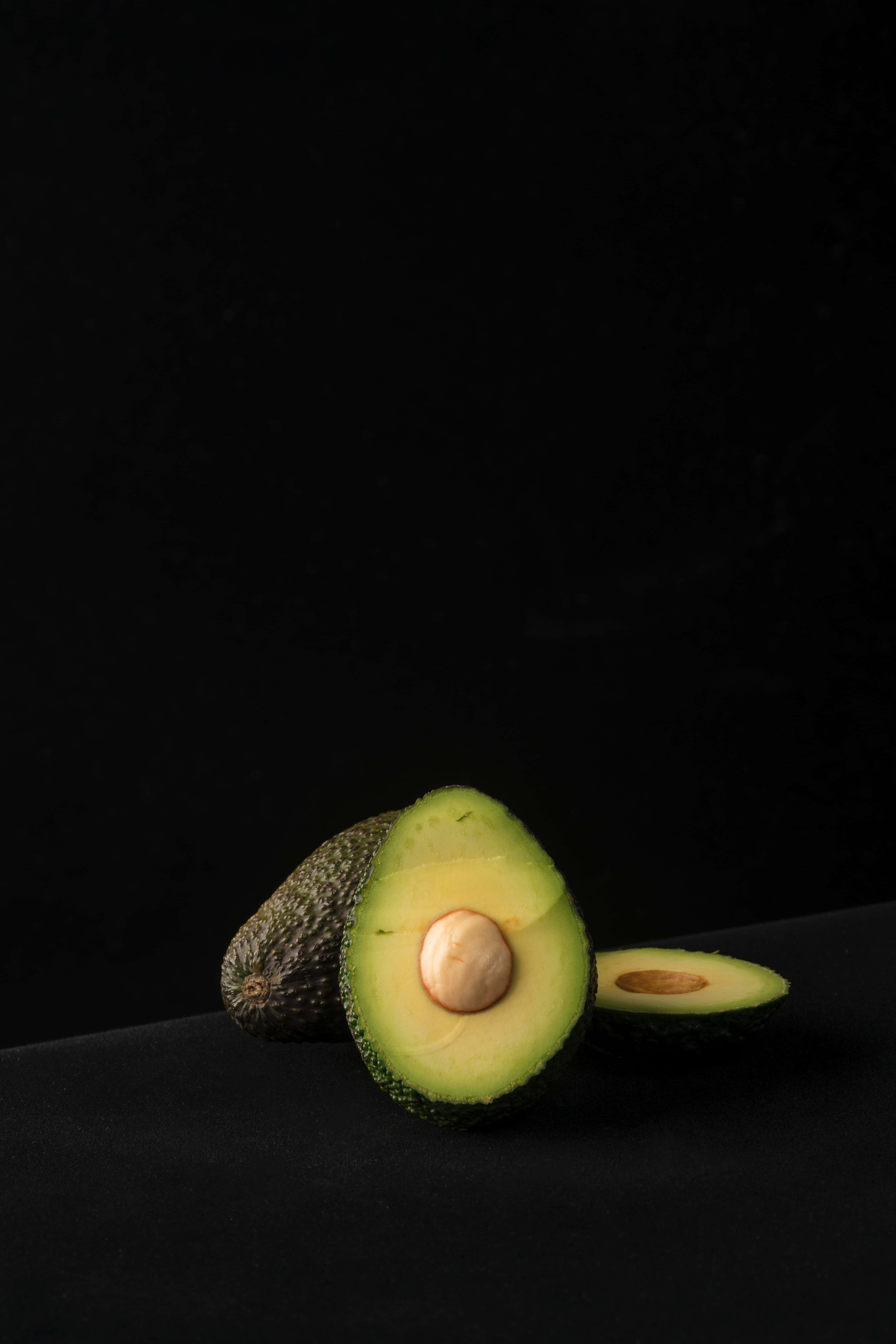 Avocado iPhone, halved avocado, creamy green flesh, 5K Phone Wallpaper