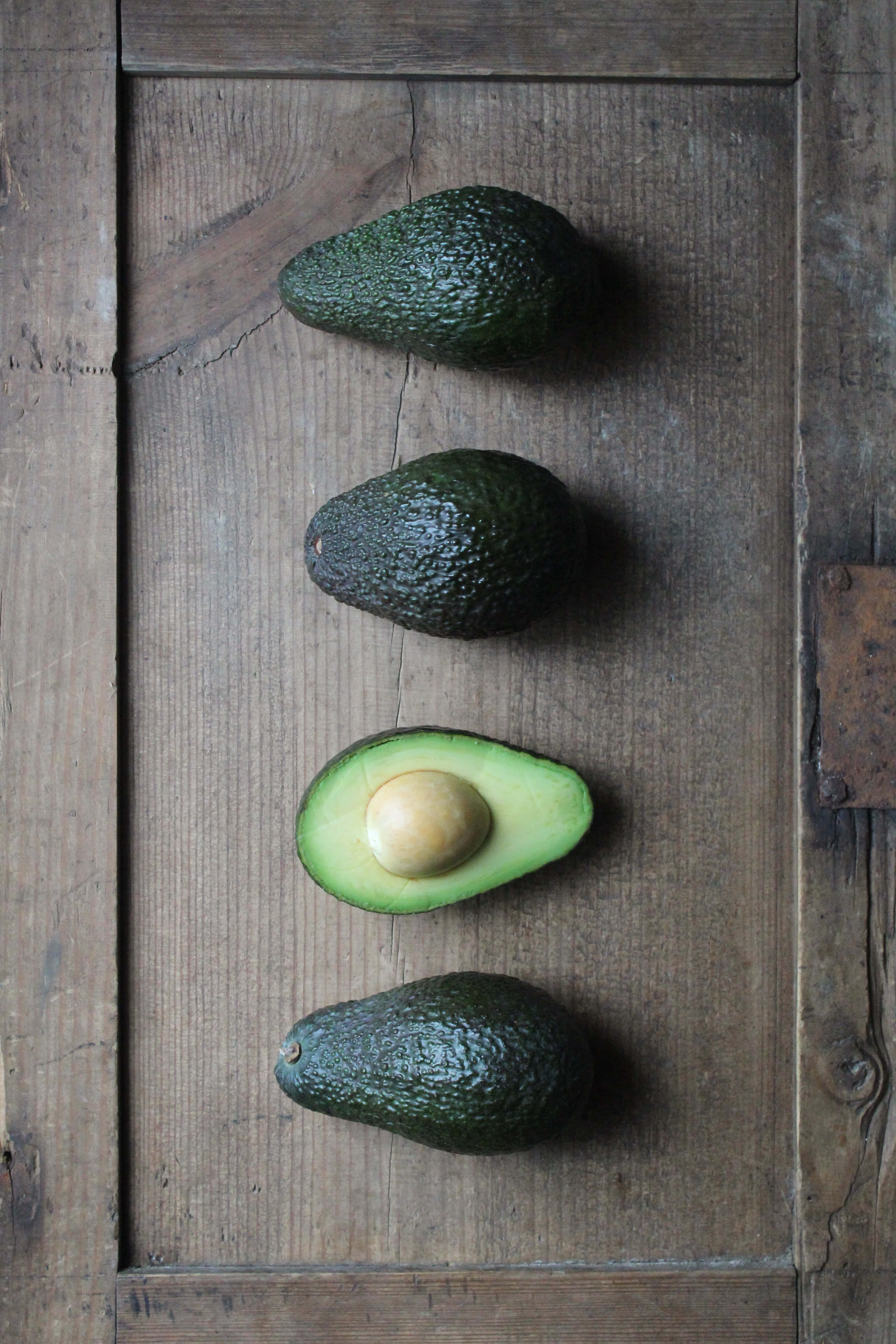 four avocados, creamy green flesh, pale seed, 5K Phone Wallpaper
