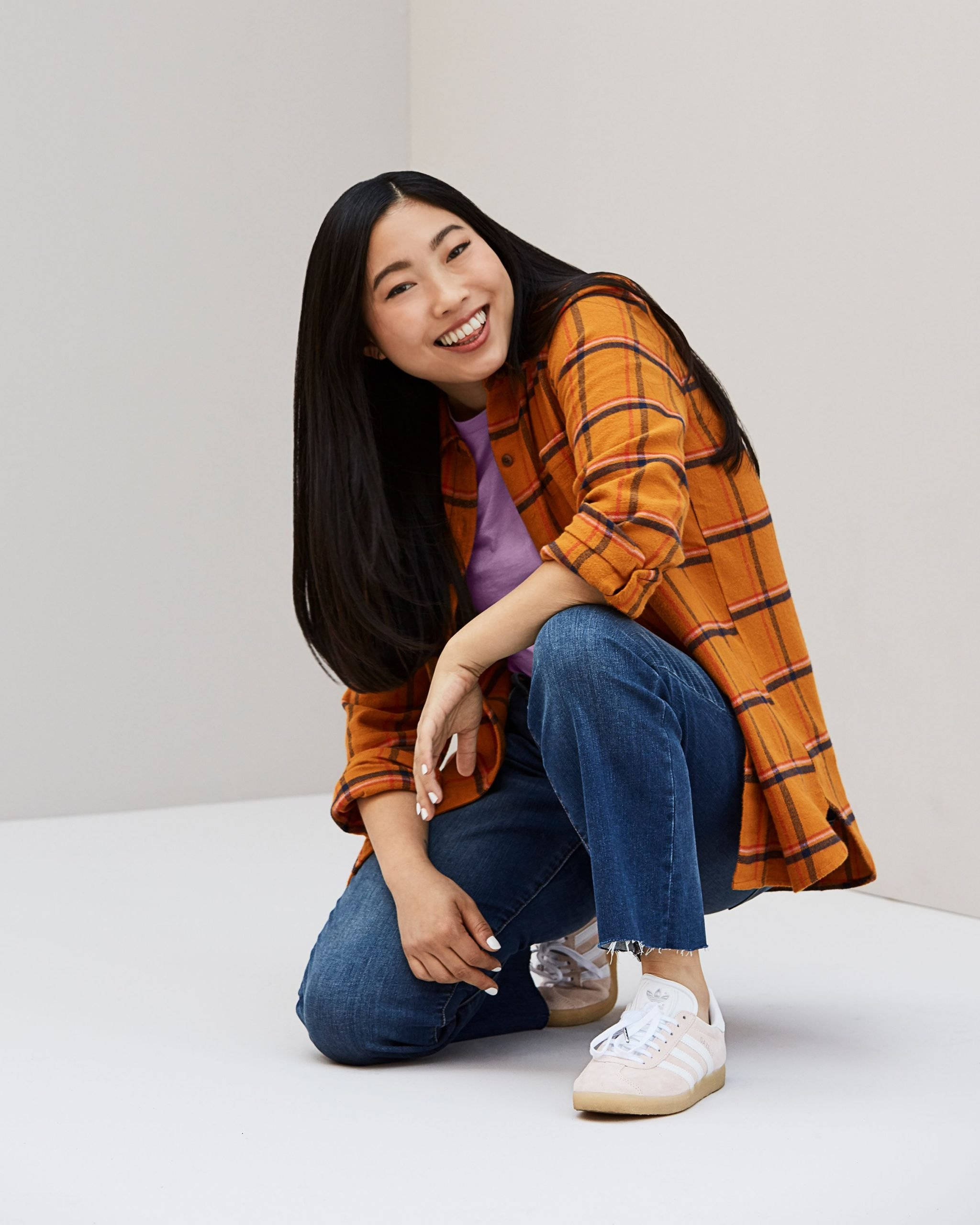 Awkwafina, orange checkered polo, long black hair, 2K Phone Wallpaper
