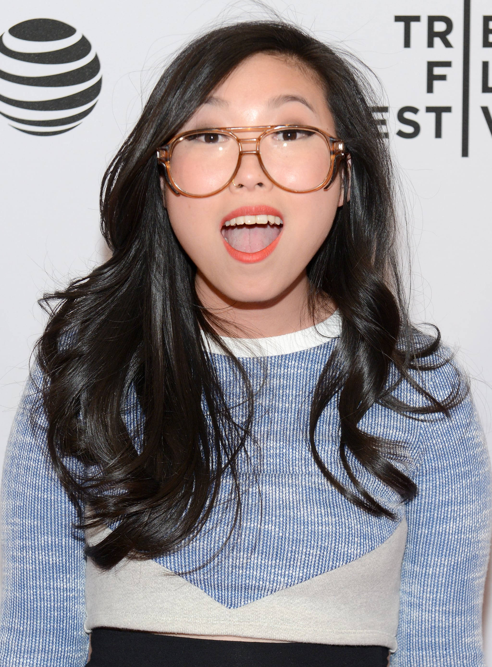 Awkwafina, dark wavy hair, large gold-rimmed glasses, 2K Phone Wallpaper