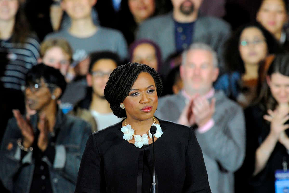 Ayanna Pressley, black suit, white floral necklace, SD Desktop Wallpaper